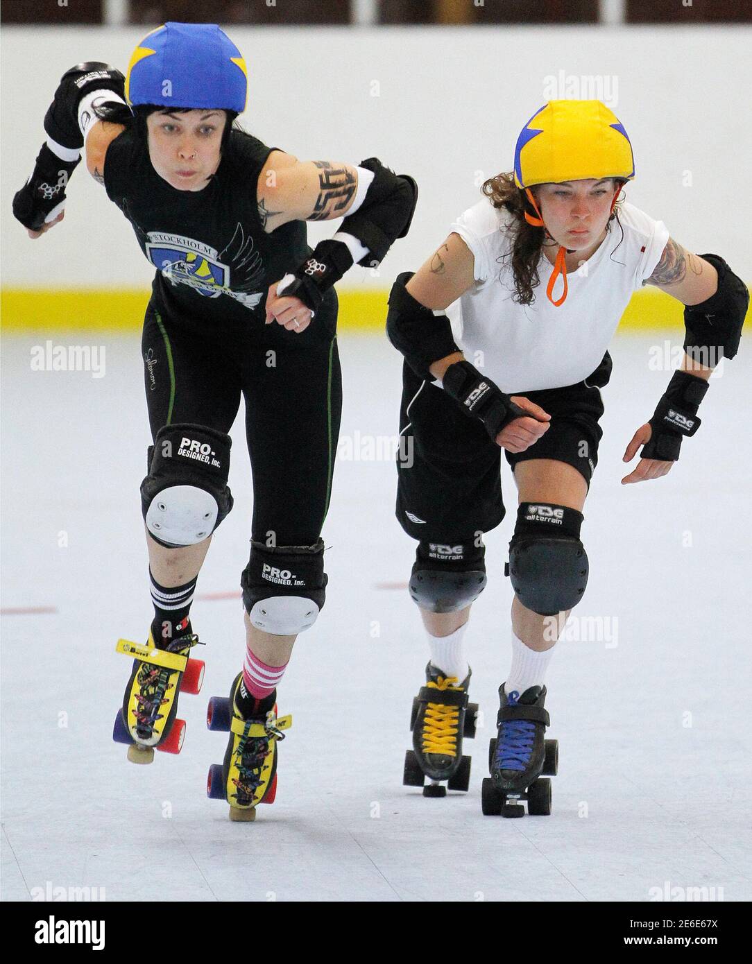 Skaters from the Stockholm Roller Derby work out during a practice session  before their women's flat track roller derby bout against the Kallio  Rolling Rainbow in Huddinge June 9, 2011. Flat track
