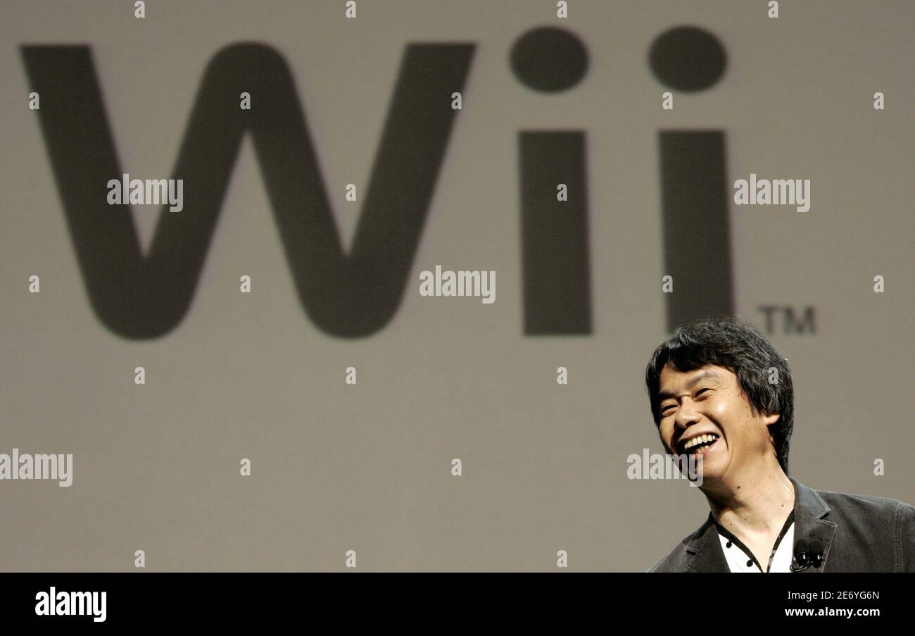 Shigeru Miyamoto, senior managing director and general manager of the entertainment  analysis and development division for Nintendo, unveils the new "Wii"  remote control device during the Electronic Entertainment Expo in  Hollywood, California