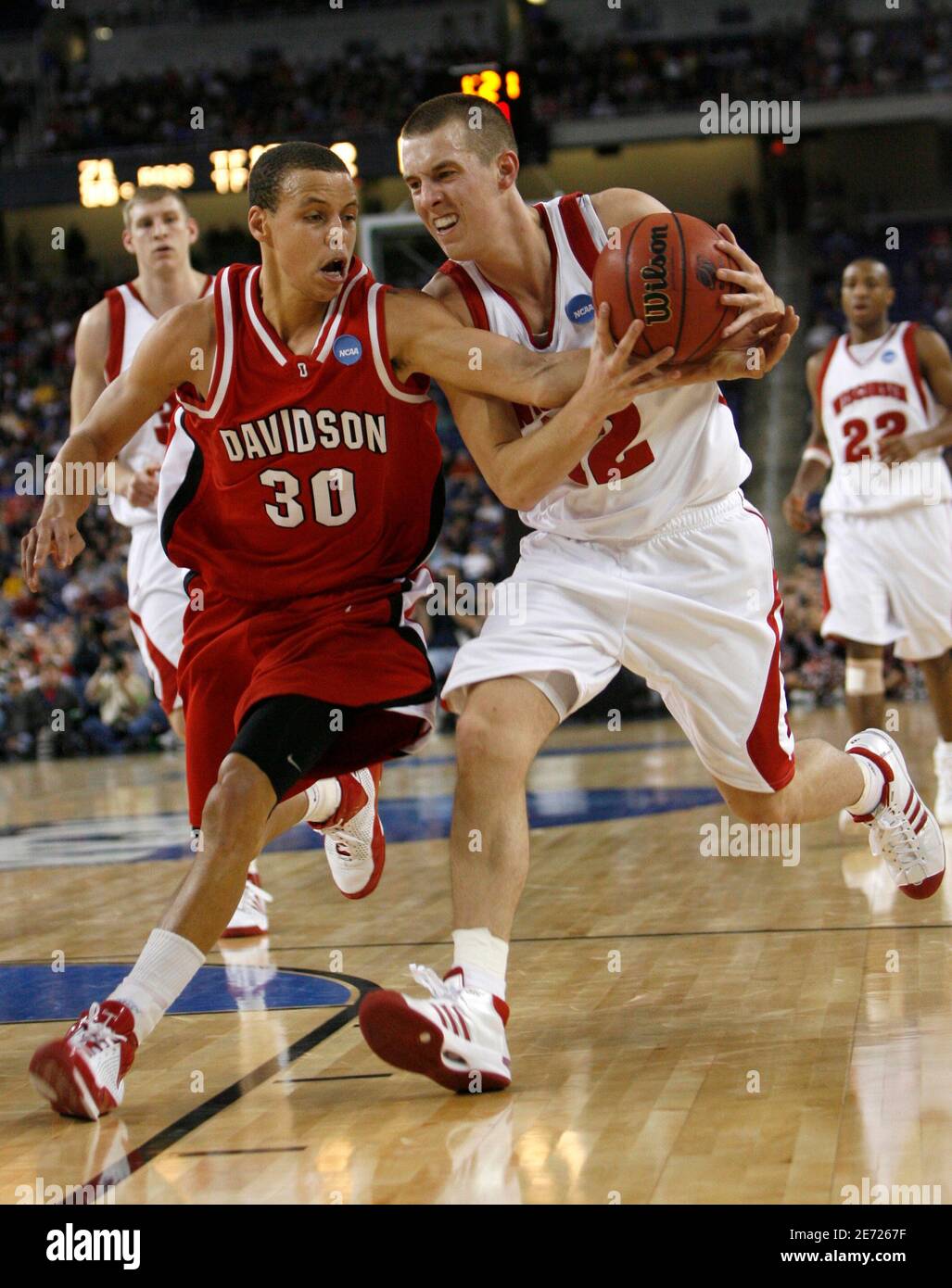 Davidson Wildcats' Stephen Curry (30) fights for the ball with Wisconsin  Badgers' Jason Bohannon during second half of their NCAA men's Midwest  Regional basketball game in Detroit March 28, 2008. REUTERS/John Gress (