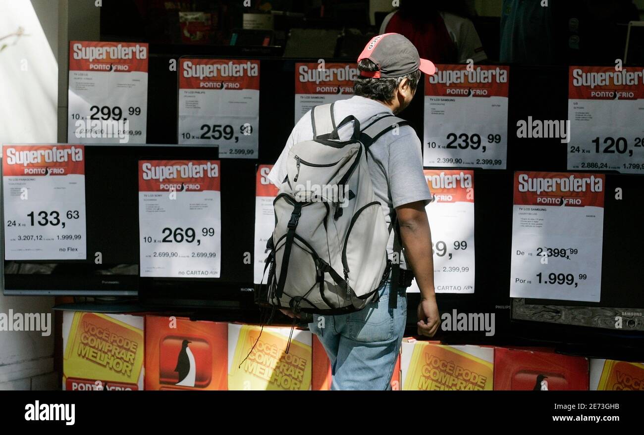 A man stands in front of the television sets at Ponto Frio store in Rio de  Janeiro July 15, 2008. At a time when the United States, the world's  largest economy, is