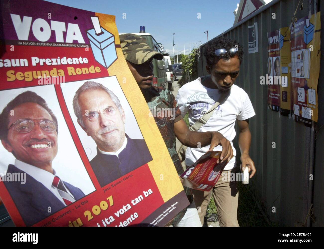 Election officials put up posters of candidates Prime Minister Jose Ramos  Horta and Fretilin party leader Francisco Guterres ahead of the second  round of the East Timor presidential elections in Dili April