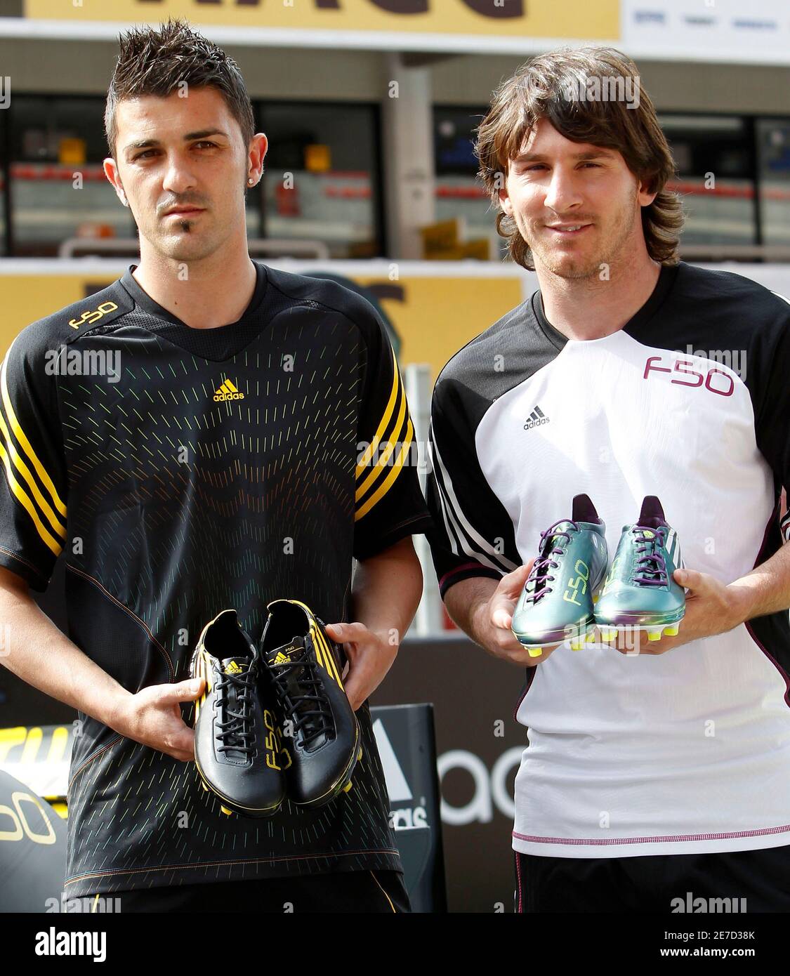Argentina's national soccer team player Lionel Messi (R) and national team player David Villa (L) display the new F50 adiZero soccer boots during promotional event at Montmelo circuit near Barcelona