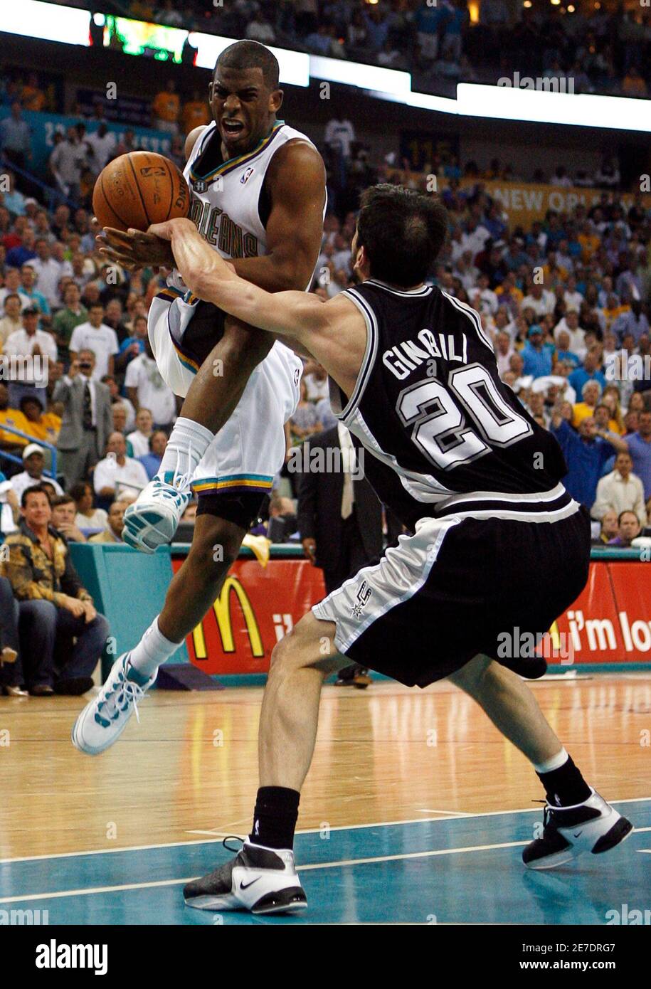 New Orleans Hornets' Chris Paul (L) loses the ball while driving to the net on San Antonio Spurs' Manu Ginobili during the second quarter in Game 2 of their second round NBA New Orleans Hornets' Chris Paul (L) loses the ball while driving to the net on San Antonio Spurs' Manu Ginobili during the second quarter in Game 2 of their second round NBA