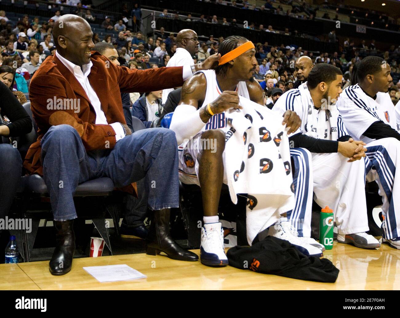 Charlotte Bobcats part owner Michael Jordan (L) puts his hand on Charlotte  Bobcats forward Gerald Wallace's head on the bench during the first half an  NBA basketball game in Charlotte, North Carolina