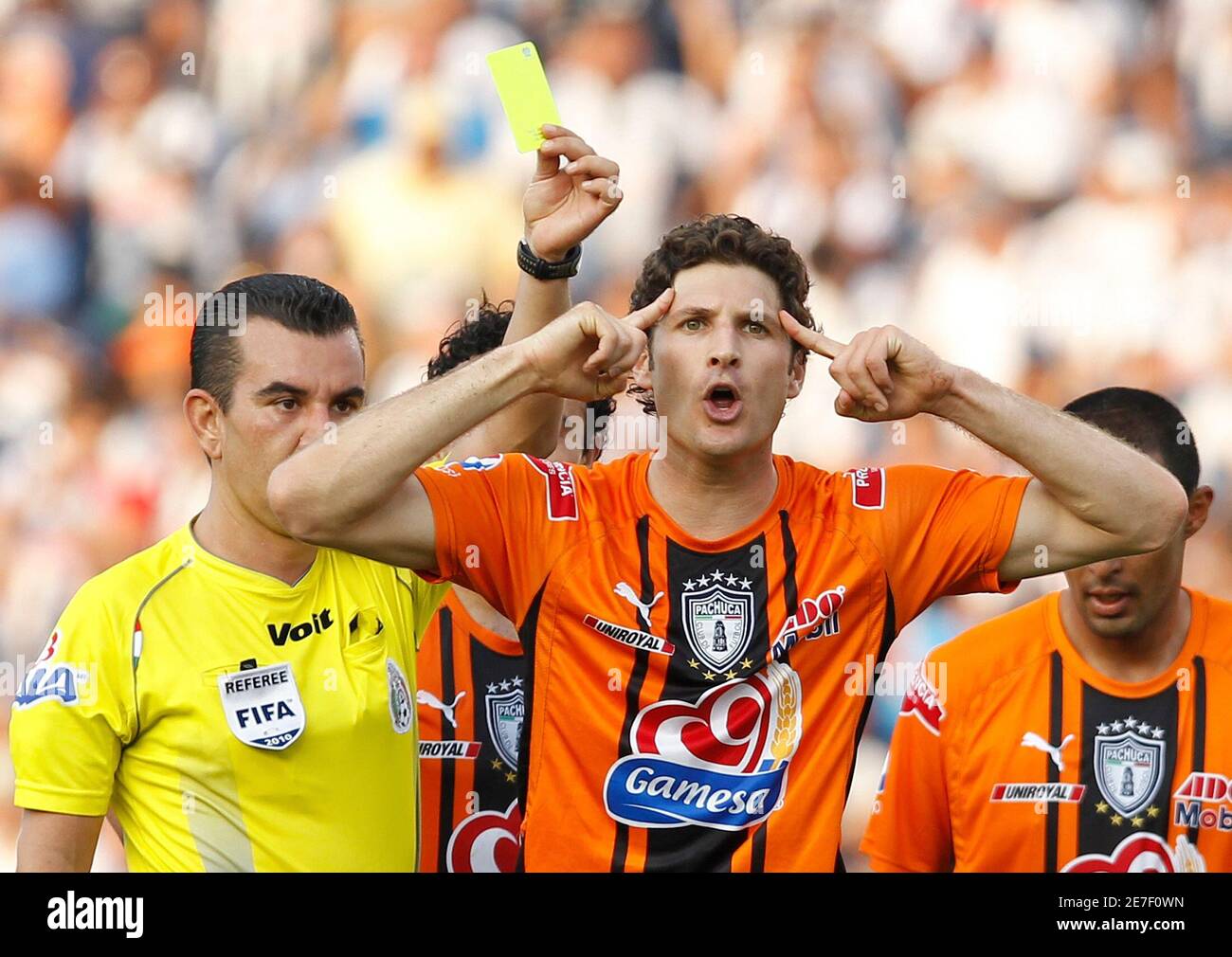 Pachuca's Javier Munoz Mustafa reacts as he receives a yellow card during  their Mexican league quarterfinal soccer match against Monterrey at the  Tecnologico stadium in Monterrey May 8, 2010. REUTERS/Tomas Bravo (MEXICO -