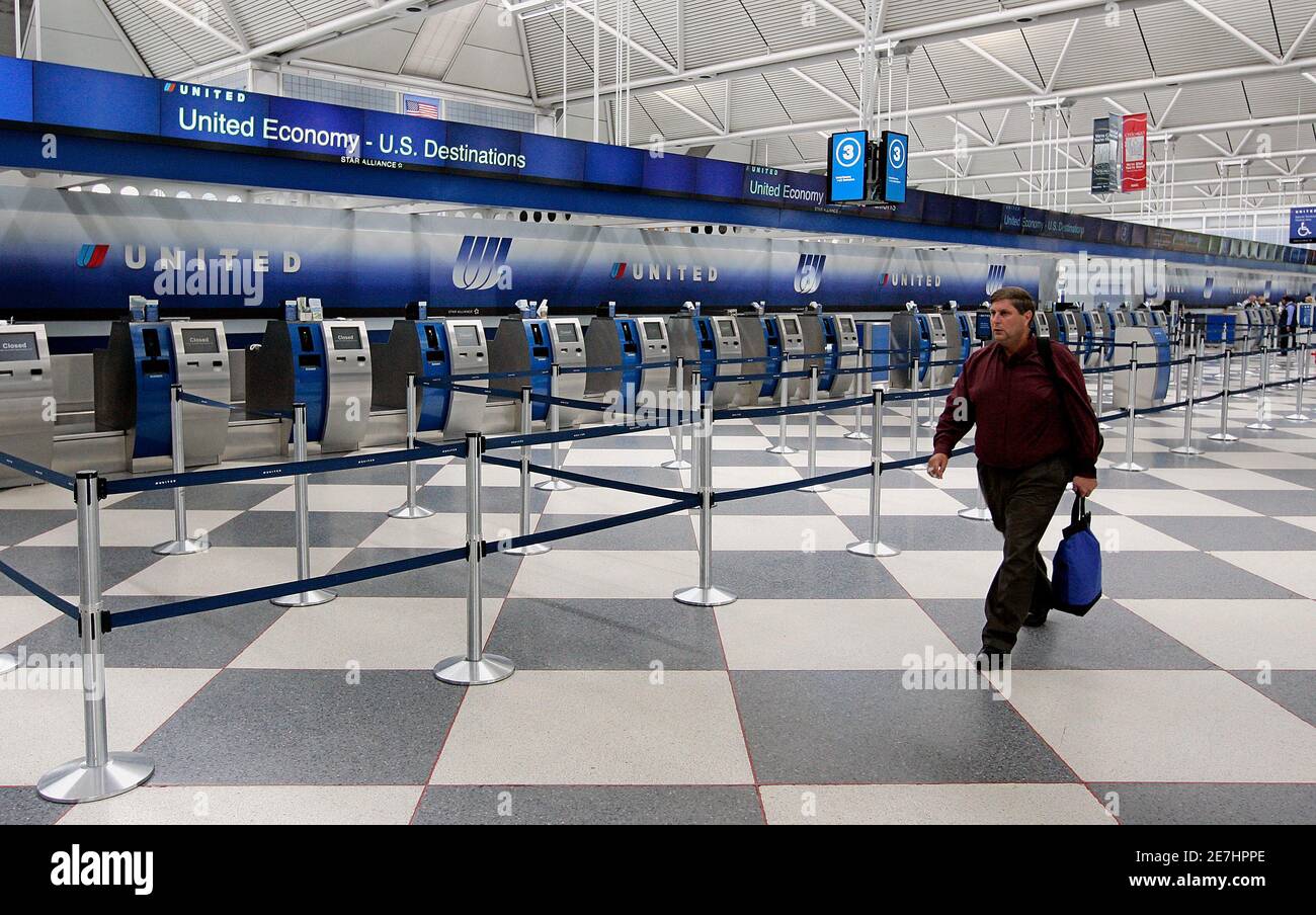 United Airlines Terminal 1 A Passenger Walks By The Empty Counter At The United Airlines Terminal At  O'hare International Airport In Chicago June 4, 2008. United Airlines  Parent Ual Corp Will Slash Its Work Force And