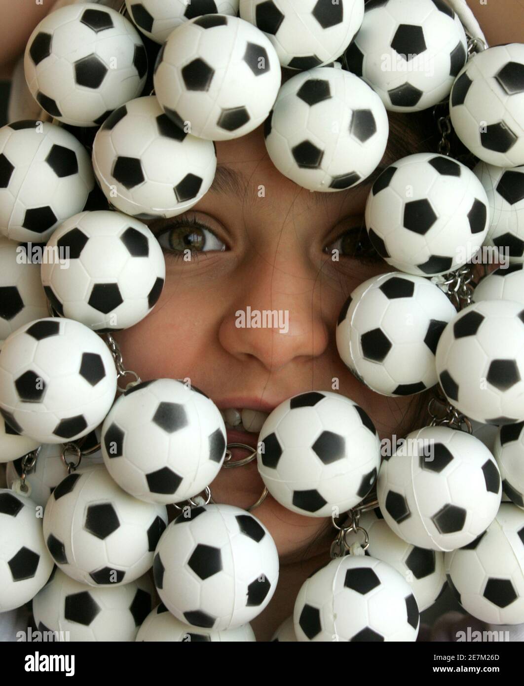 Jordanian girl display small soccer balls for sale at Friday Jara souq in  Amman June 9, 2006. The World Cup 2006 will be opened with the match  Germany vs Costa Rica in