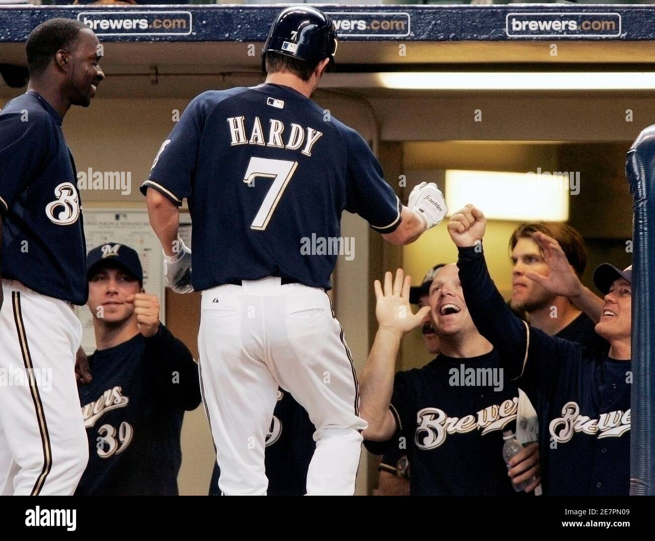 Milwaukee Brewers batter J.J. Hardy (7) is greeted by (L to R) Bill