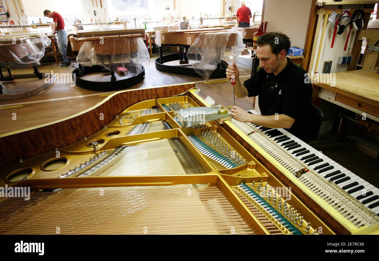 A specialist adjusts the keyboard of a Concert Grand piano at the Steinway  & Sons factory in Hamburg March 4, 2009. Steinway & Sons, a German-based  subsidiary of Steinway Musical Instruments, Inc