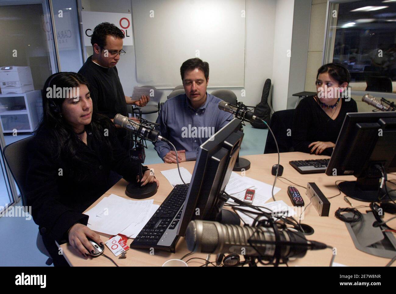 Members of the team producing the radio programme "Voices of Kidnapping"  talk on-air with a relative of a kidnapped person at Caracol radio station  in Bogota in this June 24, 2007 file