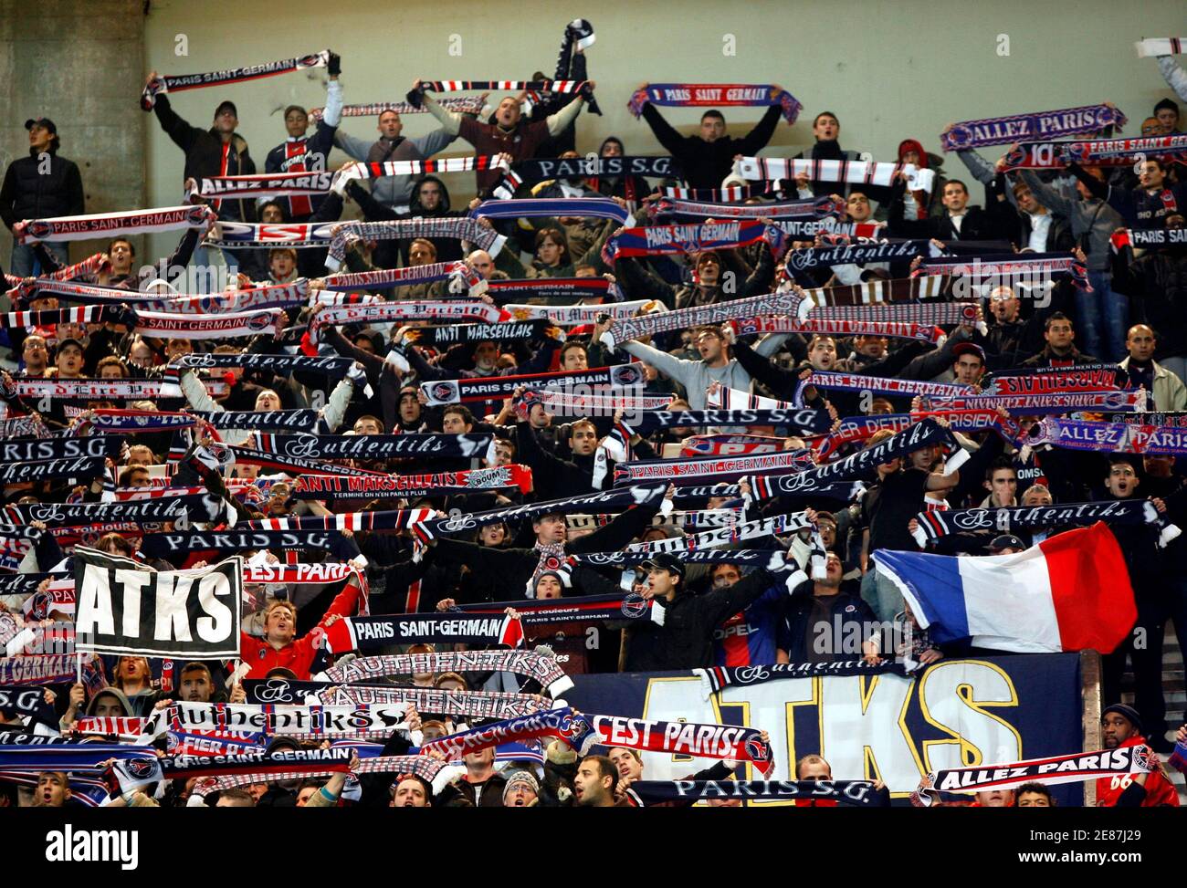 Paris St Germain's supporters cheer their team as PSG faces host Greek side  Panathinaikos in a Group G UEFA soccer match at Parc des Princes stadium in  Paris, December 13, 2006. The