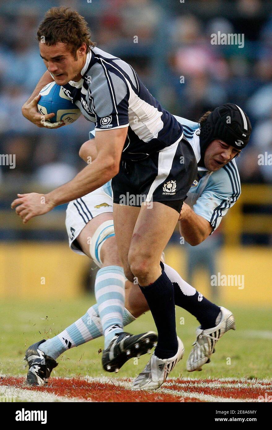 Esteban Lozada (R) of Argentina's Los Pumas tackles Scotland's Dan Parks  during their rugby union test
