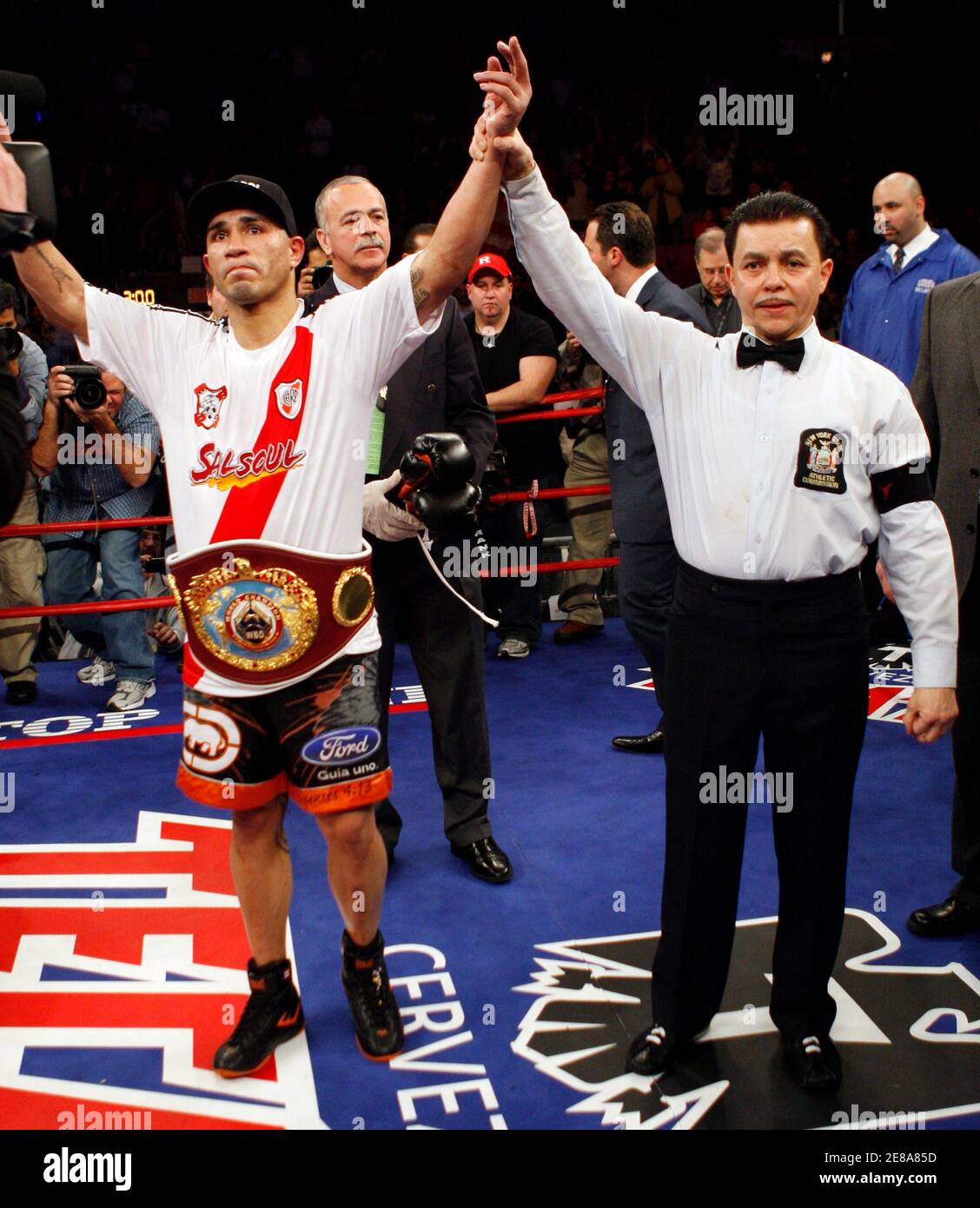 Miguel Cotto Of Puerto Rico Has His Arm Raised By Referee Benji Estevez After Defeating Of Michael Jennings Of England By Technical Knockout In Their Wbo World Welterweight Title Fight At Madison