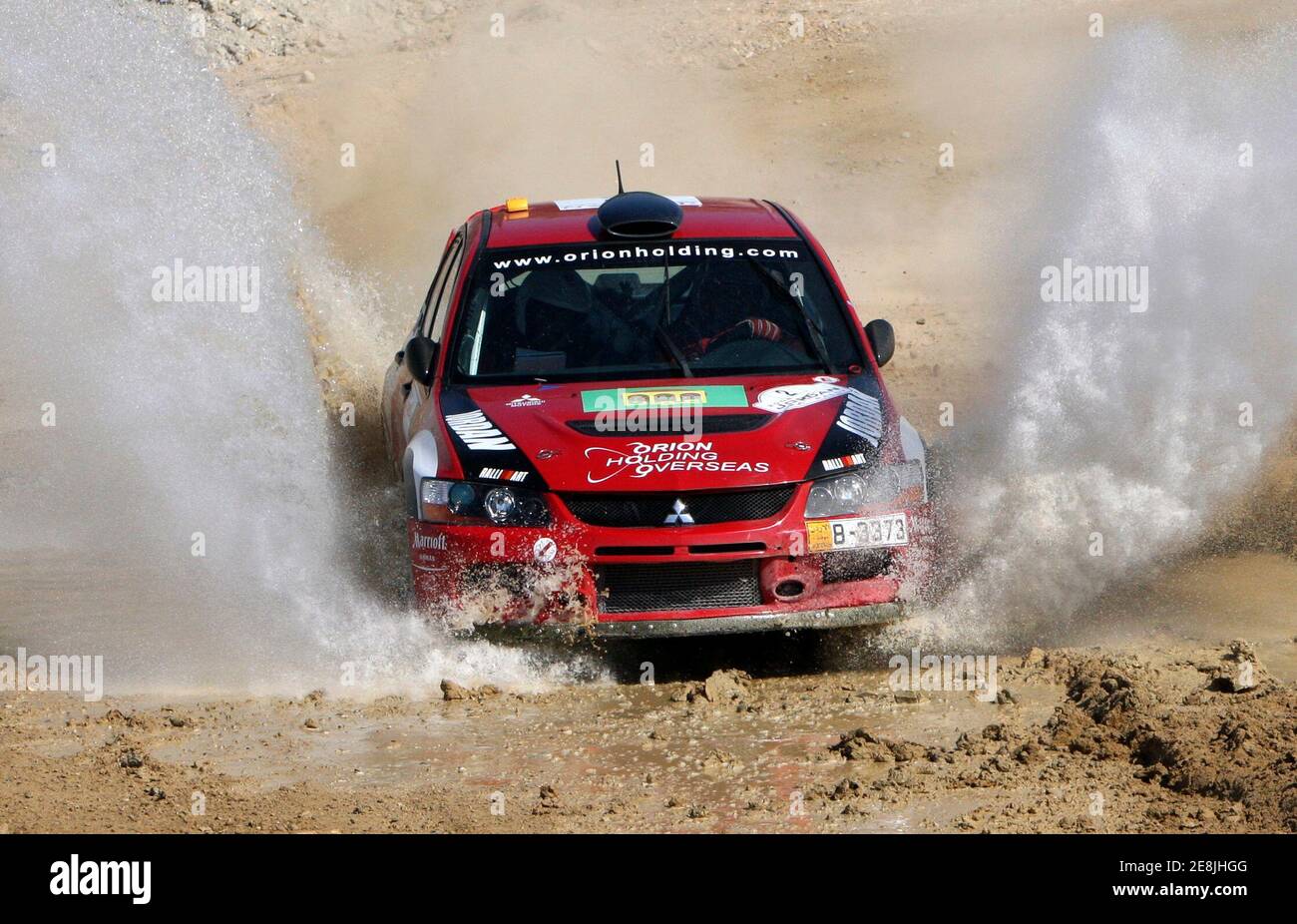 Jordanian Amjed Farrah and his Italian co-driver Nicole Arena drive their  Mistubishi Lancer Evo 9 at the first stage of the Jordan Rally 2008-Middle  East Rally Championship at the Jordanian side of
