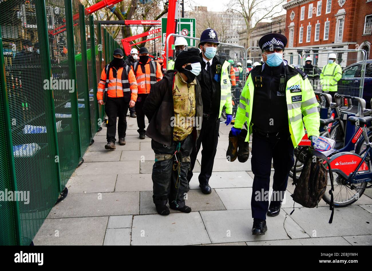 Oficiales de policía detienen a un activista por la extinción de la Rebelión mientras otros manifestantes ocupan túneles bajo Euston Square Gardens para protestar contra el ferrocarril de alta velocidad HS2 en Londres, Gran Bretaña 31 de enero de 2021. REUTERS/Toby Melville Foto de stock
