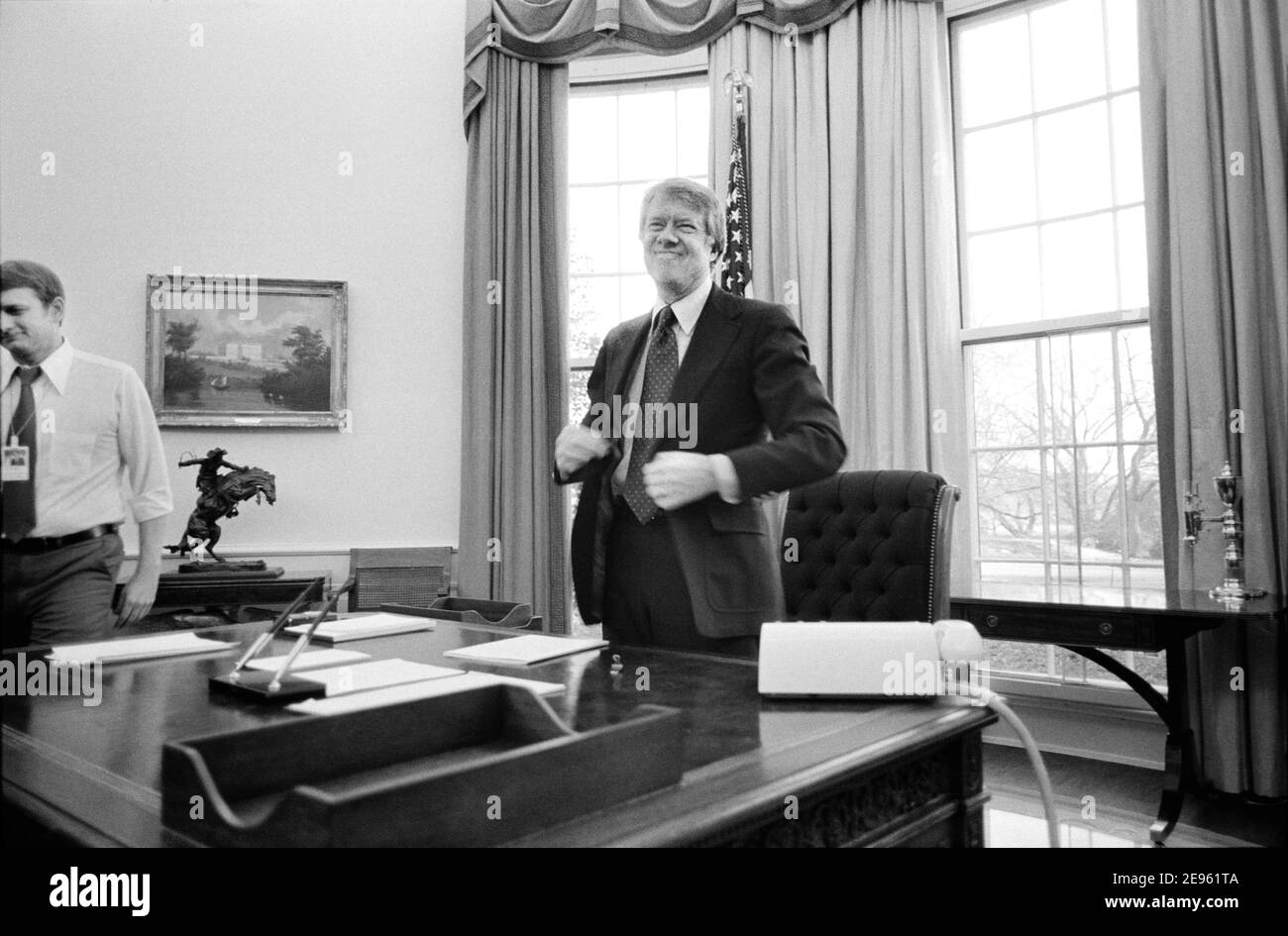 El presidente estadounidense Jimmy Carter está de pie detrás de su escritorio en la Oficina Oval de la Casa Blanca, Washington, D.C., EE.UU., Marion S. Trikosko, 2 de febrero de 1977 Foto de stock