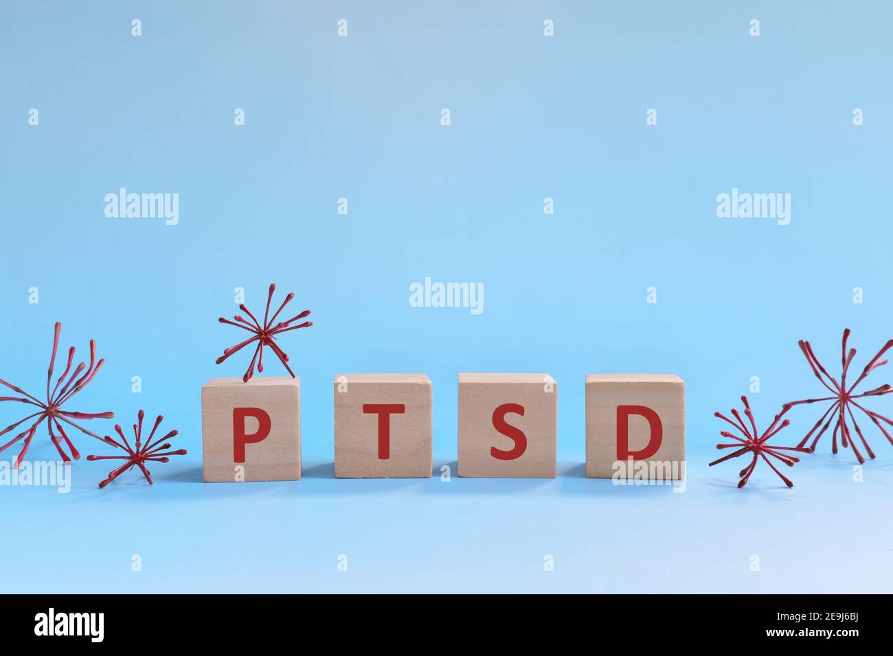 Letras PTSD en bloques de madera sobre fondo azul. Afrontando la ansiedad, el estrés, el tept y la depresión durante el concepto de pandemia de covid-19. Foto de stock