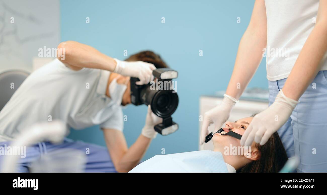 Dentista fotografiando el resultado de su trabajo Foto de stock
