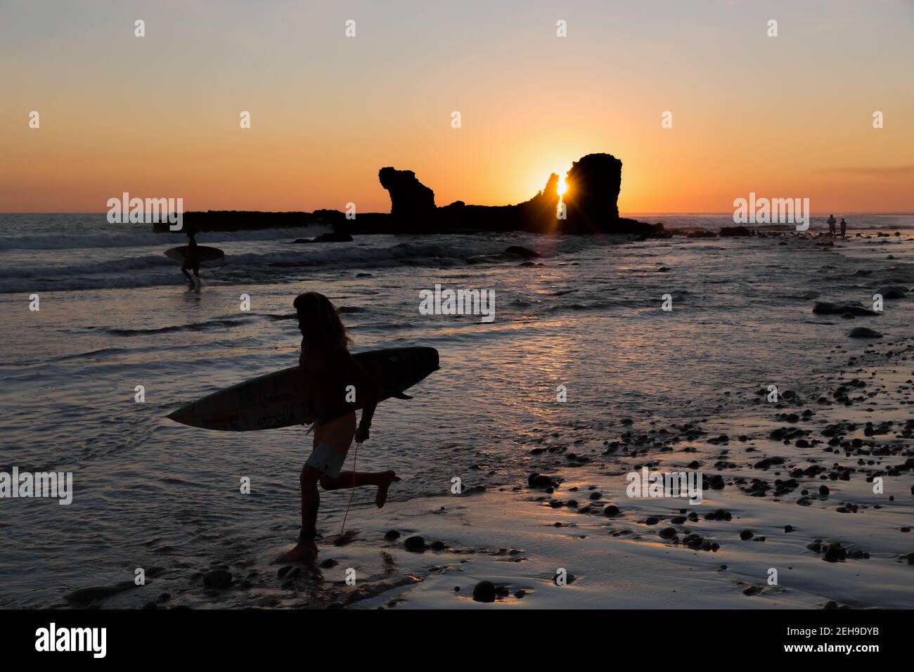 El Salvador El Tunco Silhouette de surfistas y la roca en forma de