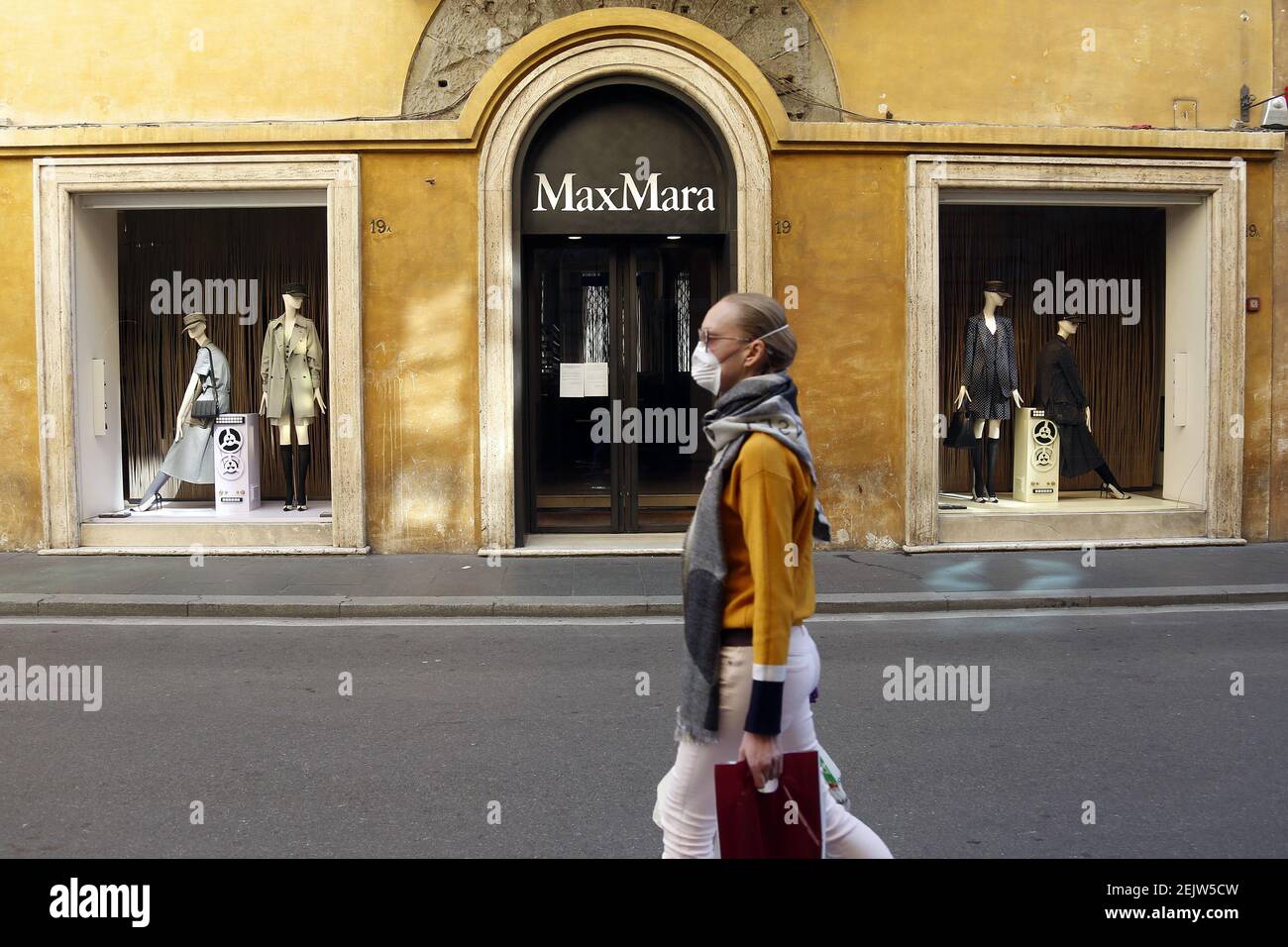 La tienda de Max Mara cerró en un desierto vía Condotti, con una mujer  enmascarada pasando por Roma el 12 de marzo de 2020. Roma el día después  del último decreto Coronavirus,