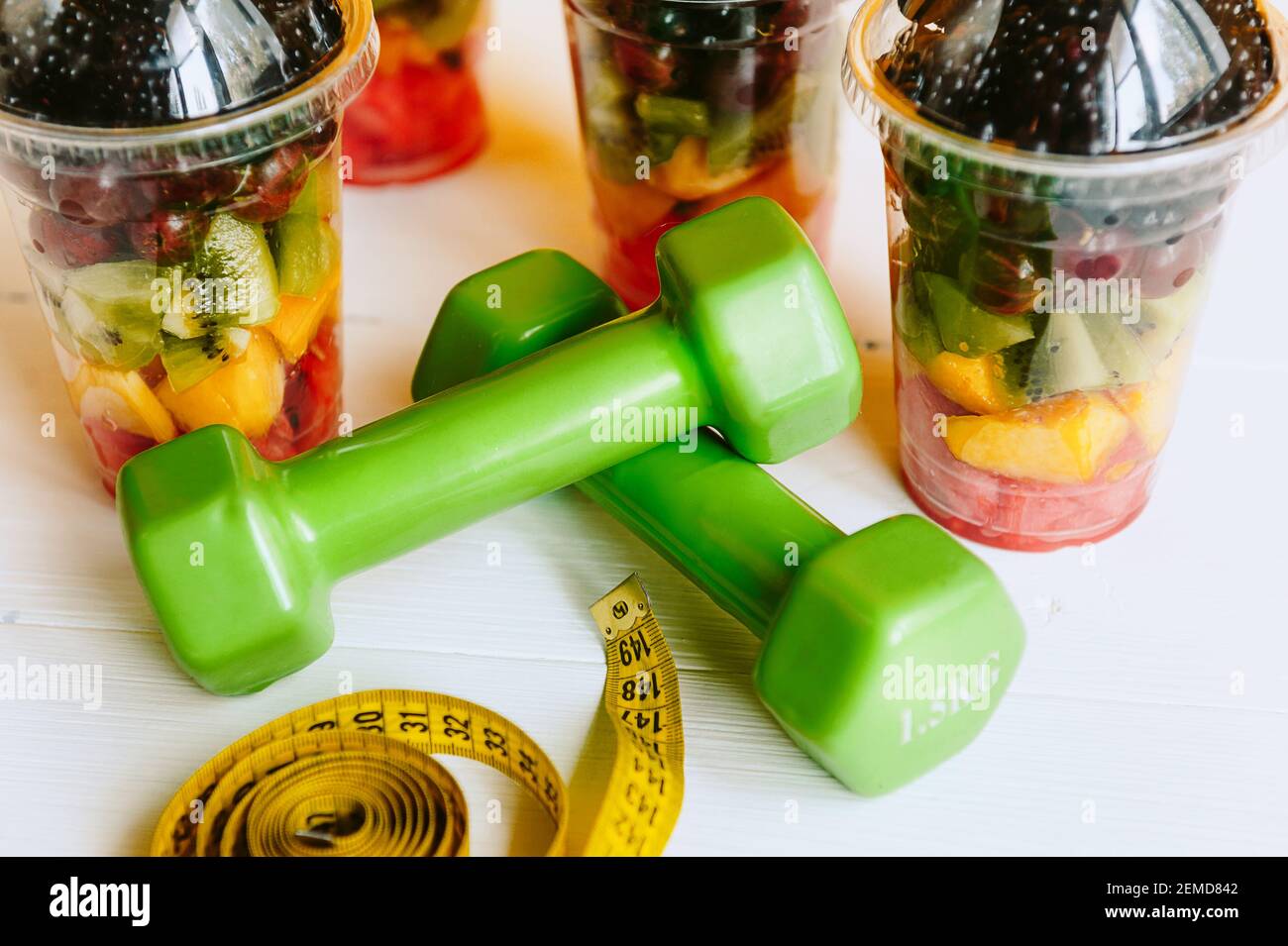 Fruta en un vaso, una campana y una cinta para medir el cuerpo. Concepto de  nutrición saludable y pérdida de peso Fotografía de stock - Alamy