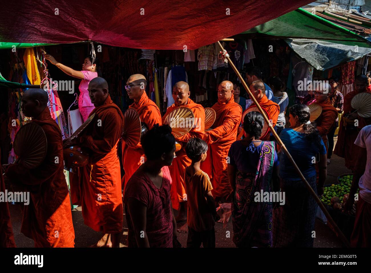 Monjes budistas recolectando limosnas por la mañana en el mercado de Pazundaung en Yangon, Myanmar. Foto de stock