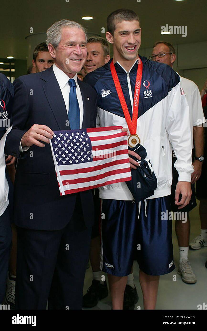 El presidente George W. Bush hace una foto con el medallista de oro de natación olímpica de EE.UU. Michael Phelps durante su visita el domingo 10 2008 de agosto al Centro acuático Nacional en Beijing, donde Phelps ganó su primera medalla de oro olímpica en la medley individual de 400 metros de hombres. Foto de stock