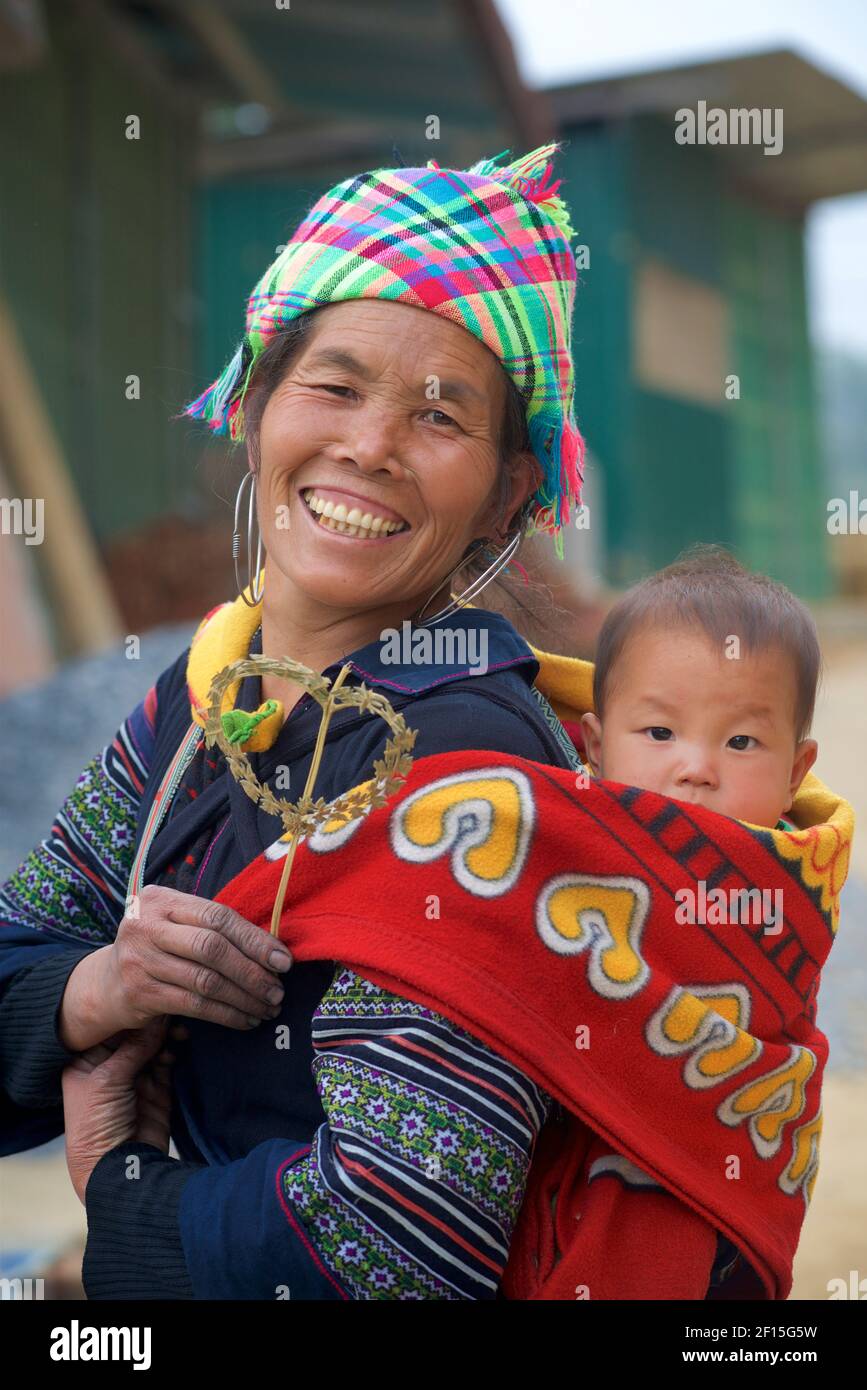 Mujer vietnamita llevando a su hijo en la espalda, Sapa, Provincia de Lao Cai, norte de Vietnam. Hmong tribu. Foto de stock