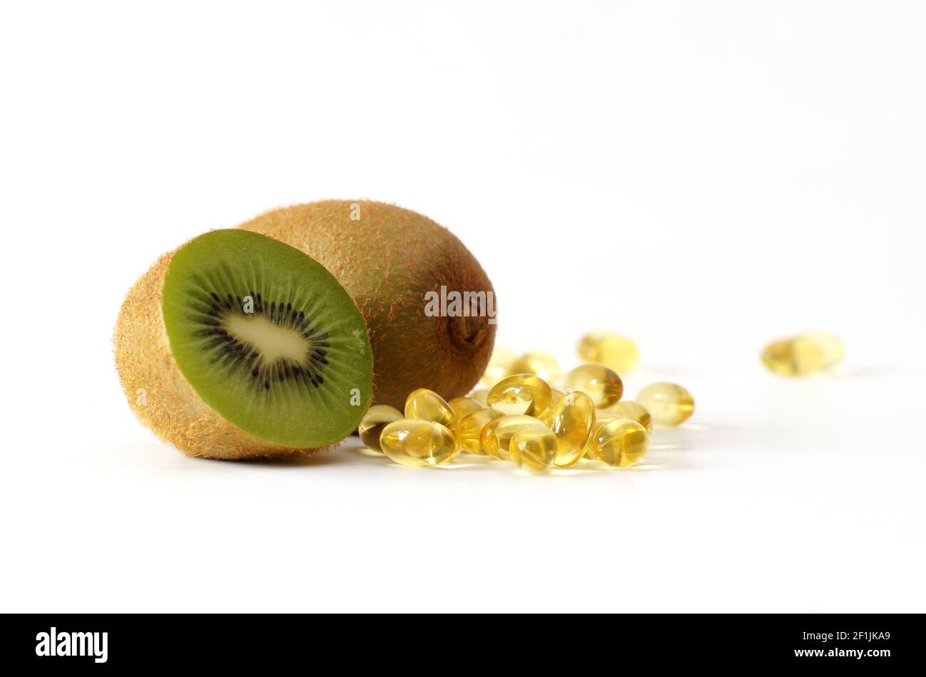 Pastillas de vitaminas cápsulas y kiwi fruta saludable alimentos buenos  para sistema inmunológico Fotografía de stock - Alamy