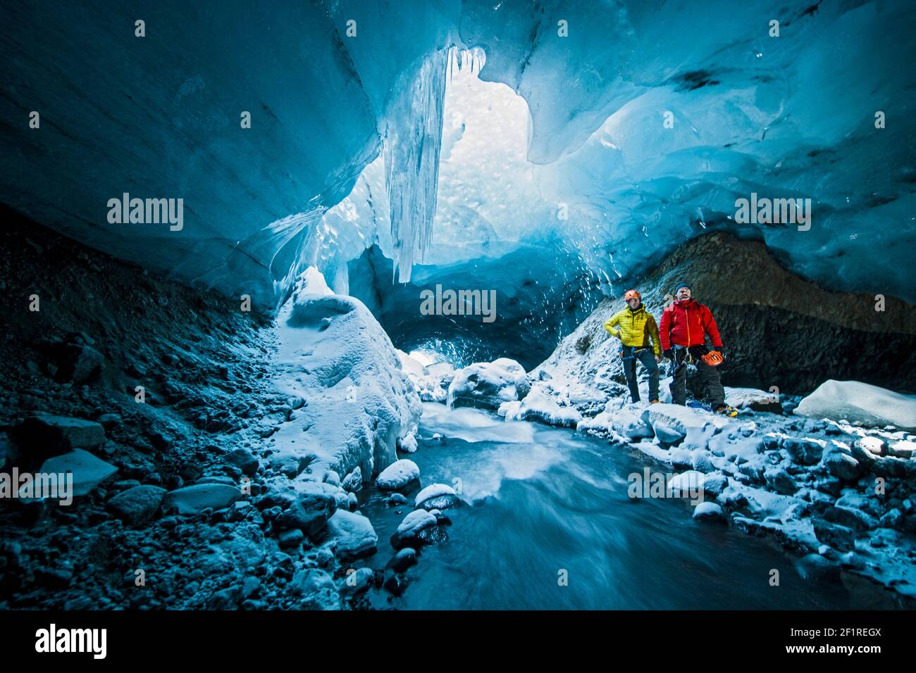 Hombres explorando la cueva de hielo en Thórsmörk - Islandia Foto de stock