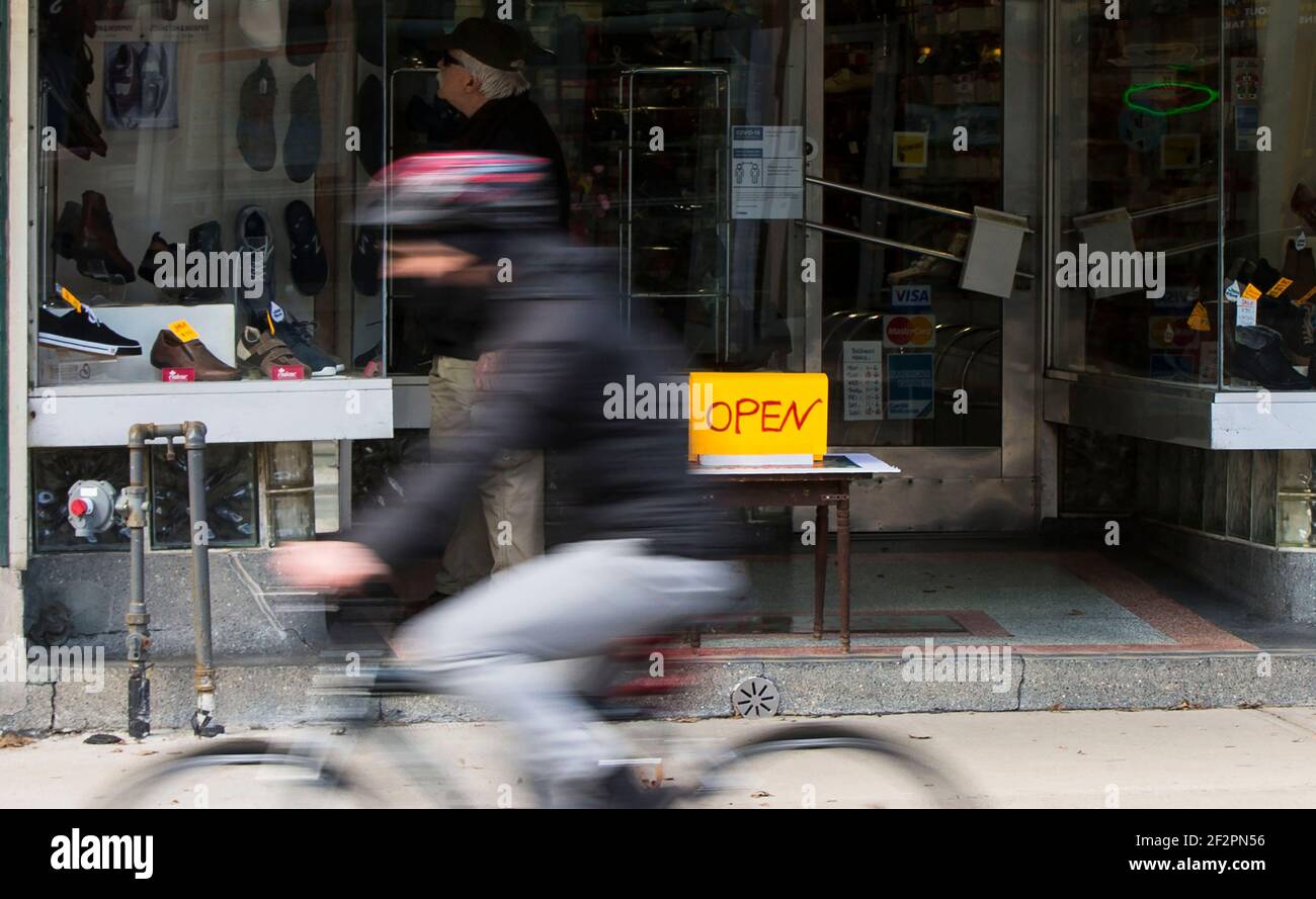 Toronto, Canadá. 12th de marzo de 2021. Un signo 'ABIERTO' se ve frente a  una zapatería en Toronto, Canadá, el 12 de marzo de 2021. La tasa de  desempleo de Canadá cayó