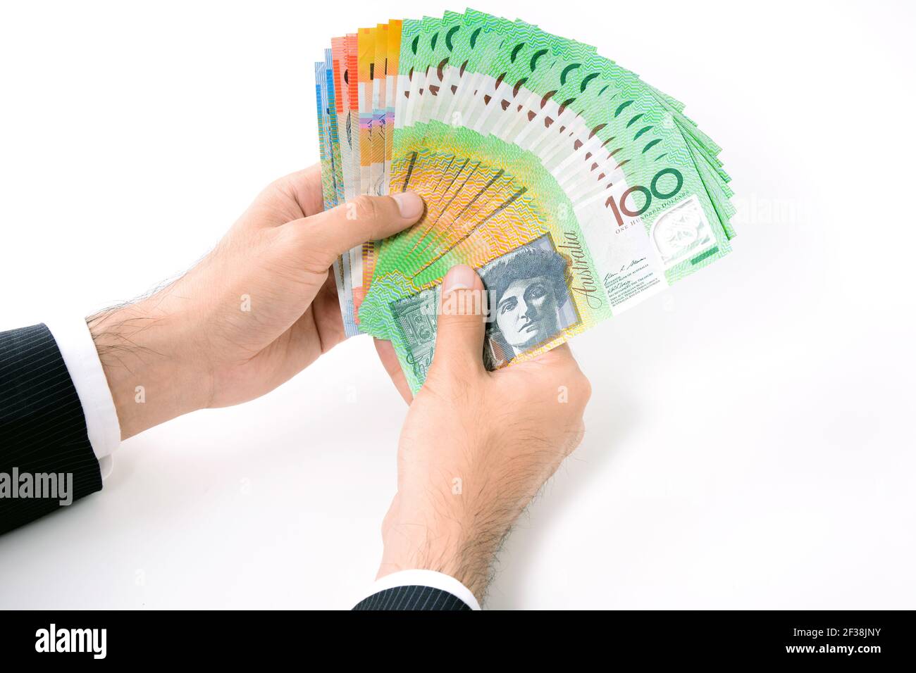 Hombre de negocios tiene dinero, billetes en dólares australianos (AUD), sobre fondo blanco Foto de stock