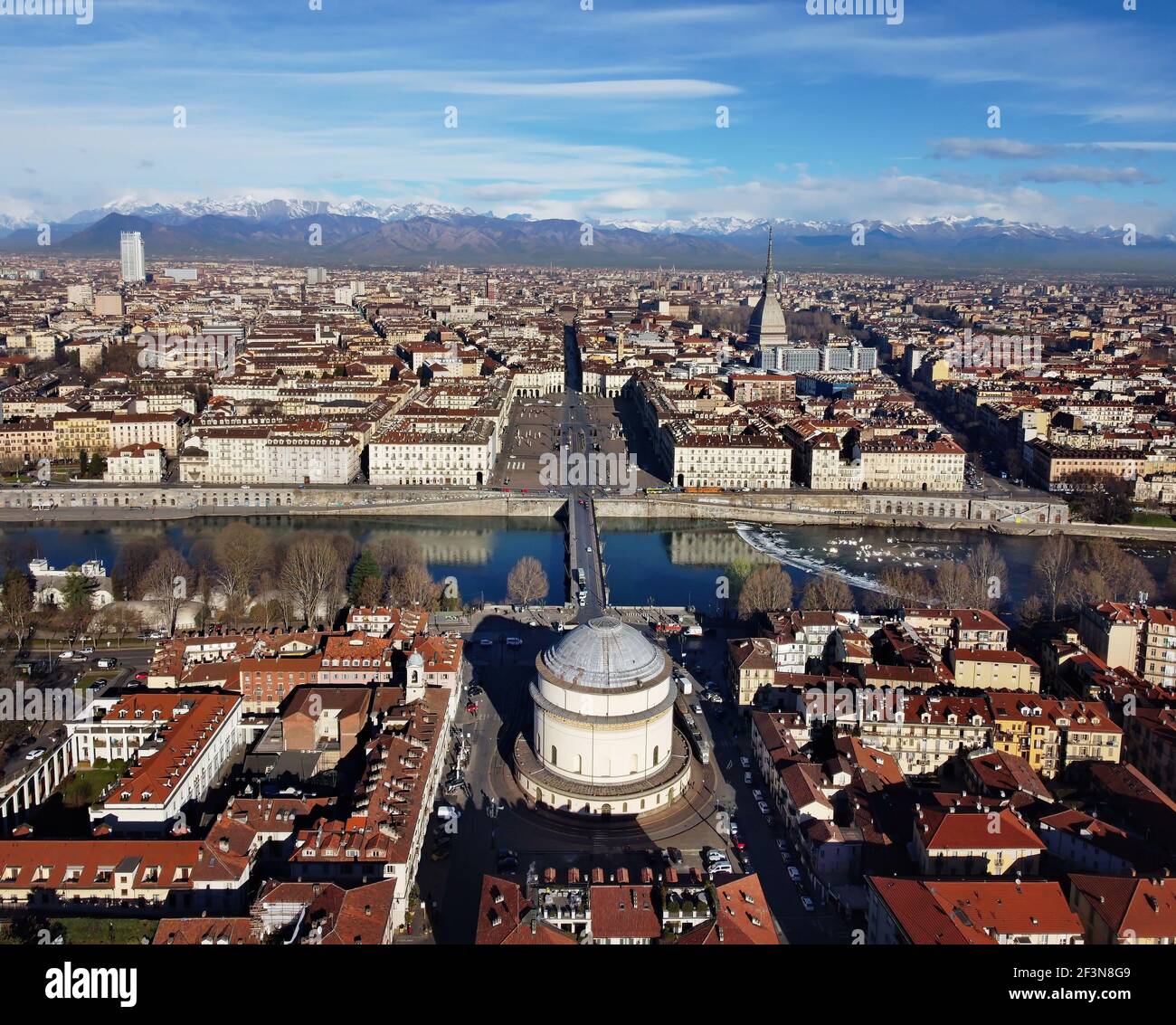 Vista aérea del centro de la ciudad de Turín, en Italia, en un día soleado, con Mole Antonelliana y los Alpes en el fondo. Foto de stock
