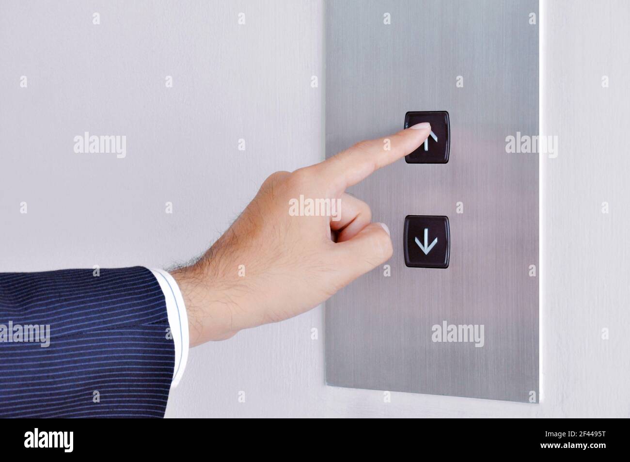 Businessman mano tocando la señal de subida en el panel de control de elevación Foto de stock