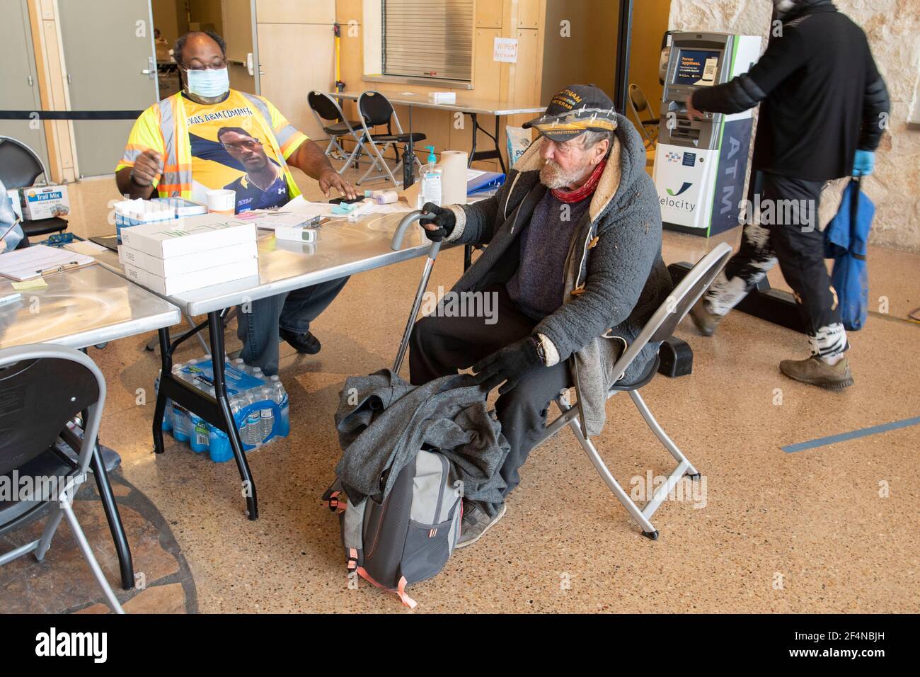Austin, TX EE.UU. Feb 20, 2021: Veterano sin hogar de 63 años se registra en un refugio de la ciudad en el sur de Austin para alojar a los austinitas sin hogar. Muchos quedaron sin lugar para ir durante las recientes tormentas de invierno en Texas. ©Bob Daemmrich Foto de stock