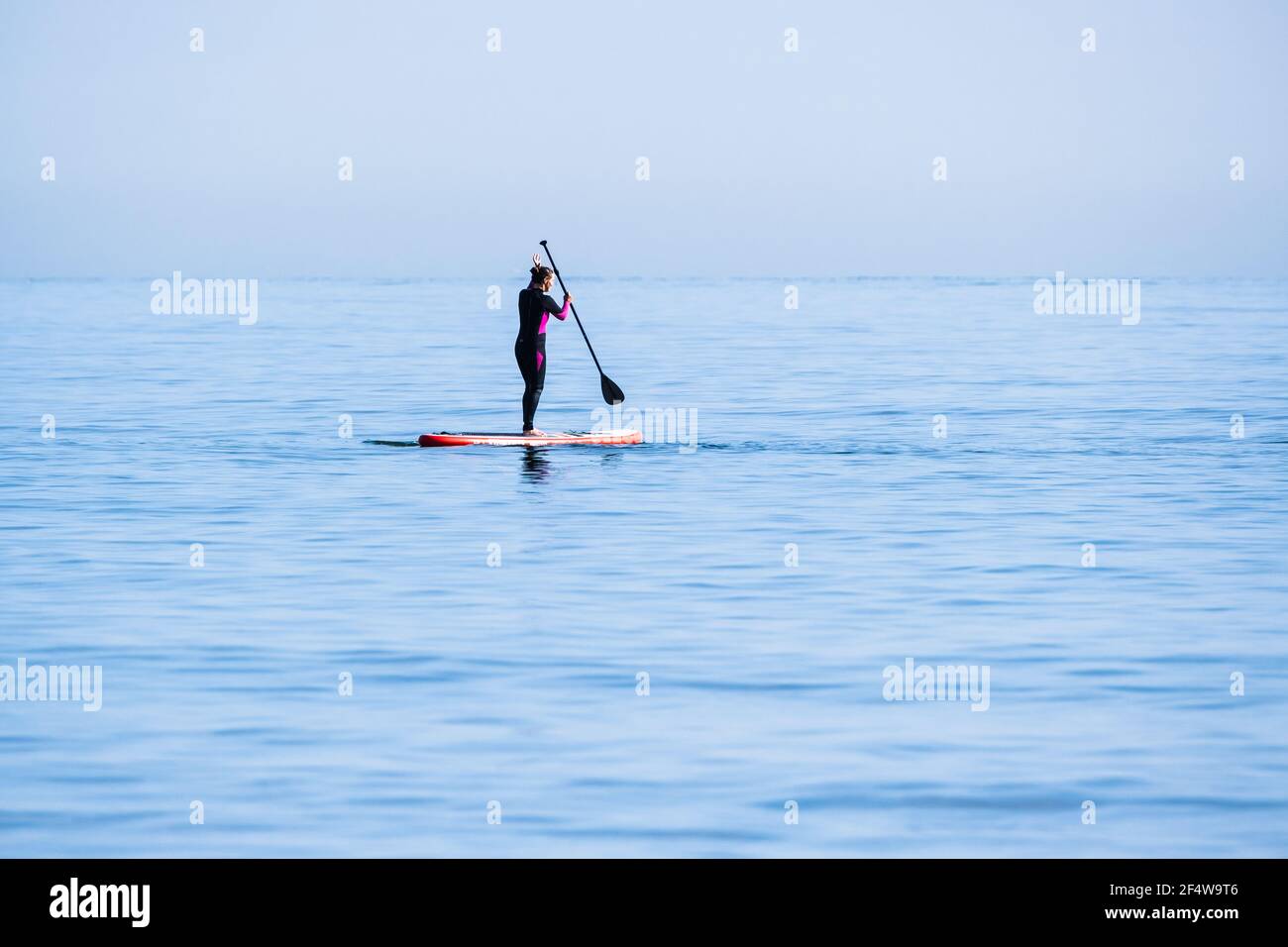 Mujer remando en el mar en Tynemouth Foto de stock