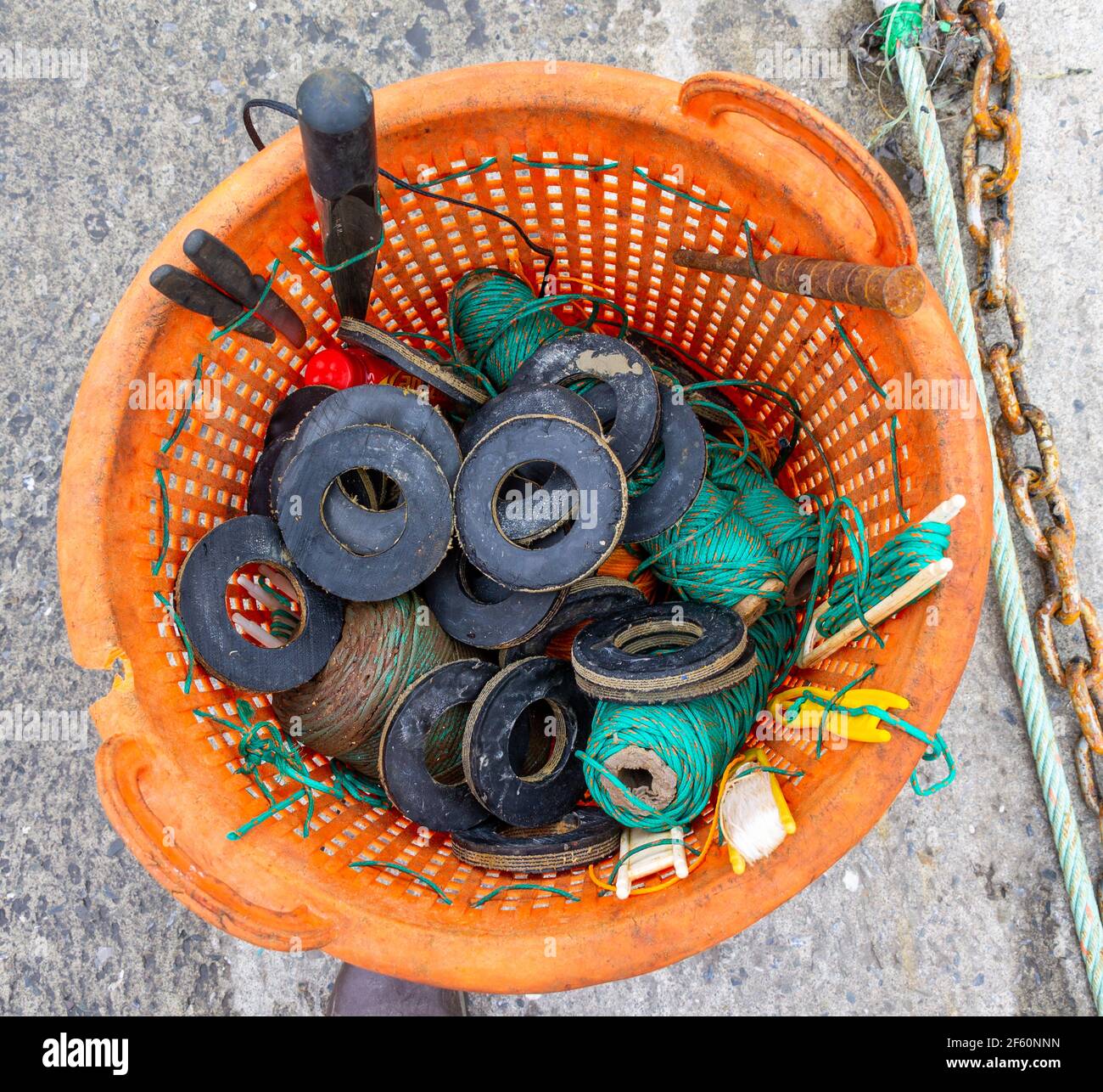 Kit de reparación de redes de arrastre en cesta naranja. Foto de stock