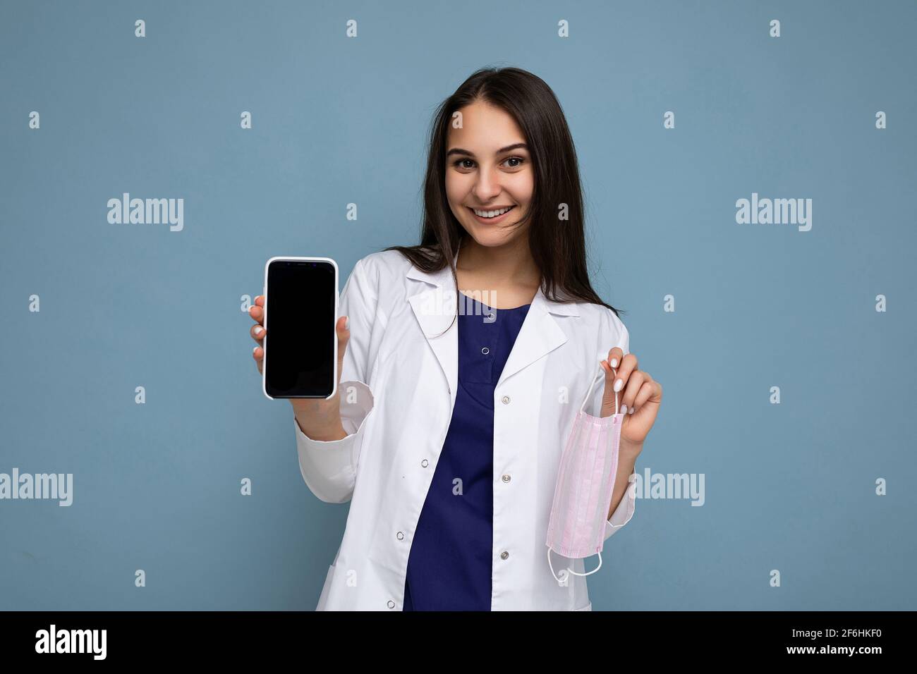 Foto de mujer joven hermosa y sonriente buen aspecto de vestir casual  elegante conjunto de pie aislado en el fondo con espacio de copia de  sujeción smartphone Fotografía de stock - Alamy