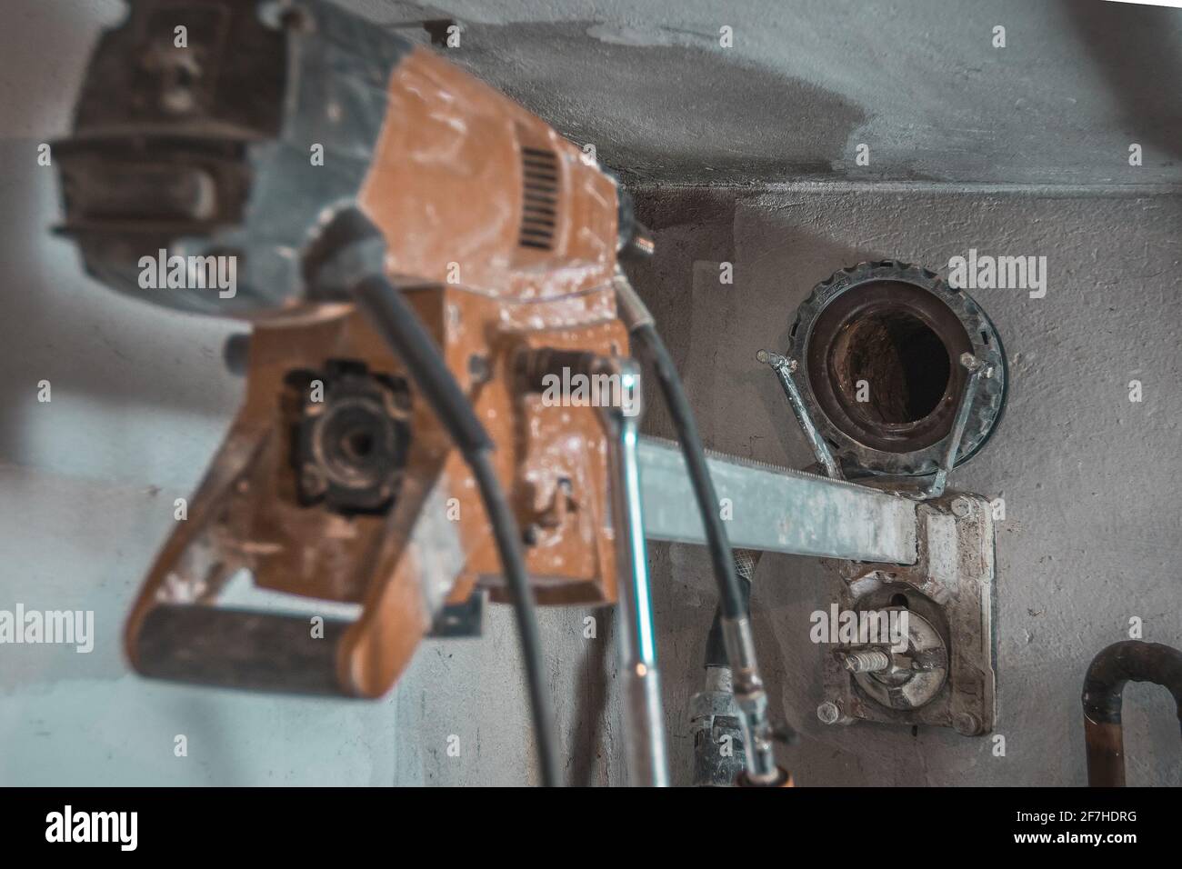 Máquina para taladrar agujeros en la pared de hormigón. Taladro profesional  rojo para hacer agujeros en las paredes. Vista posterior con orificio  visible en la pared Fotografía de stock - Alamy