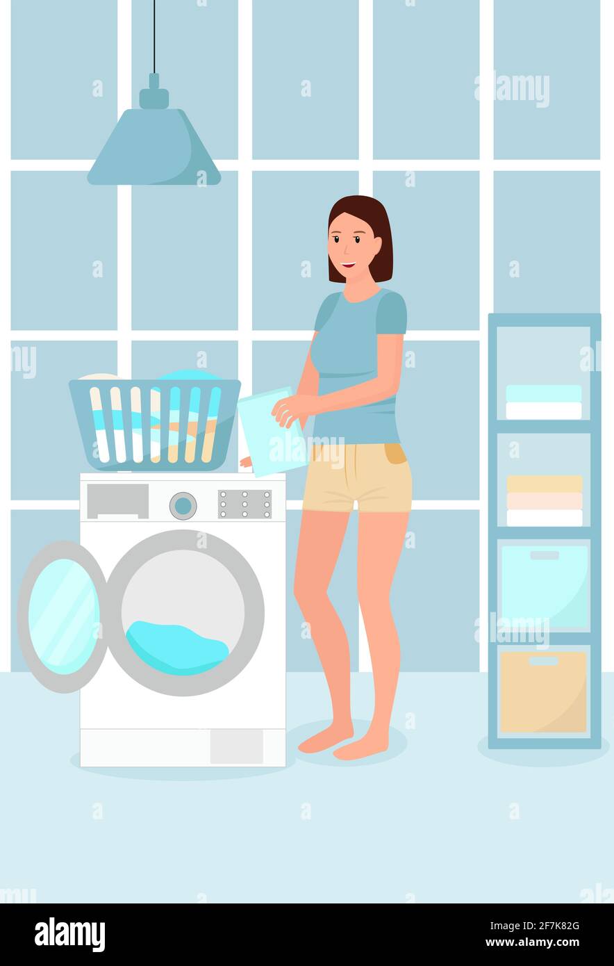La chica lava la Mujer en el cuarto de baño con cesta de ropa y lavadora. Lavandería en casa. Concepto, la niña está involucrada en el hogar Imagen de stock -