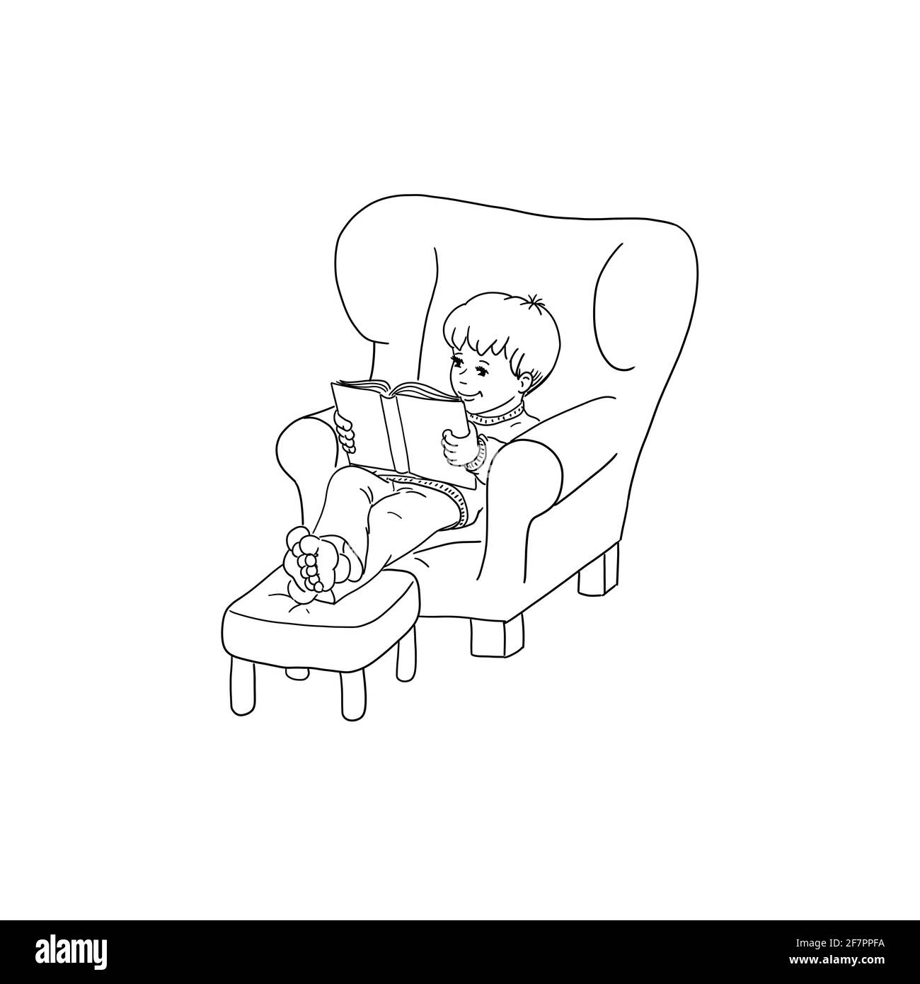 El niño se sienta cómodamente en un sillón descalzo pies sobre el taburete cómodamente lee libro infantil fascinado perdido en la infancia disfrutar ganar tiempo libre Foto de stock