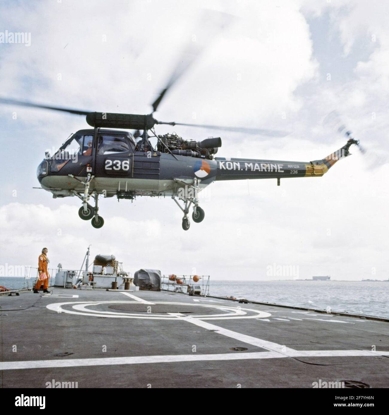 El Westland Wasp Mk.1, Serie 2 y 2a (AH-12A) con número de registro 236 (1966-1981) sobre la cubierta de vuelo de HR.Ms Van Galen (1967-1987). En el horizonte el muelle cubierto (muelle 6) del nuevo patio nacional. Foto de stock