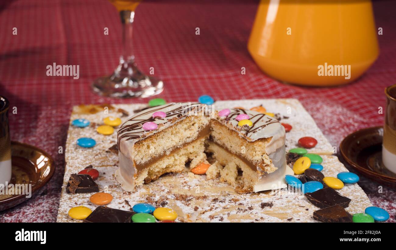 Una foto de una torta de chocolate medio partida con caramelos de  diferentes colores alrededor Fotografía de stock - Alamy