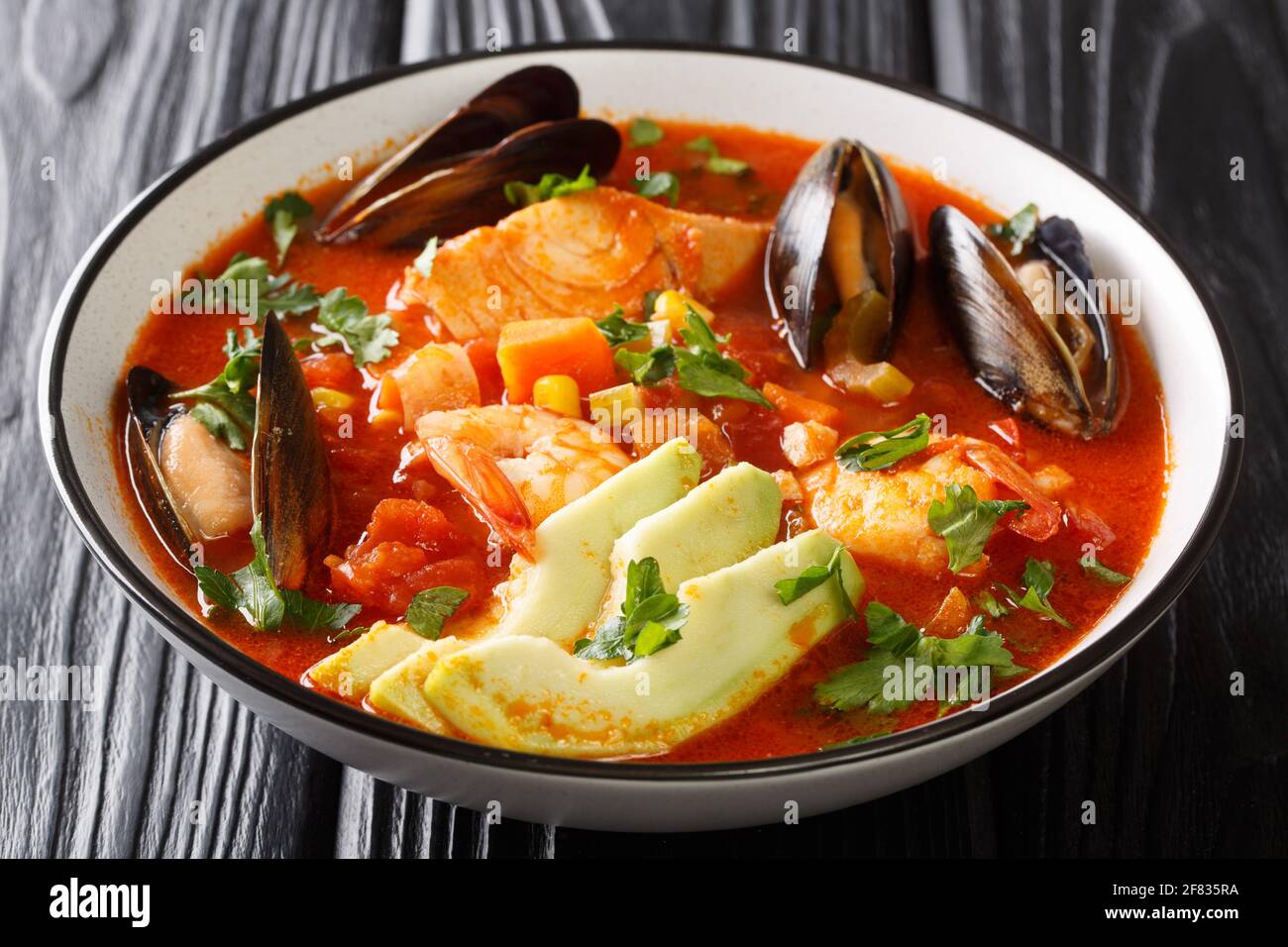 Caldo De Mariscos Receta sopa de mariscos con bacalao, camarones,  mejillones, verduras y aguacate cerca en un bol sobre la mesa. Horizontal  Fotografía de stock - Alamy