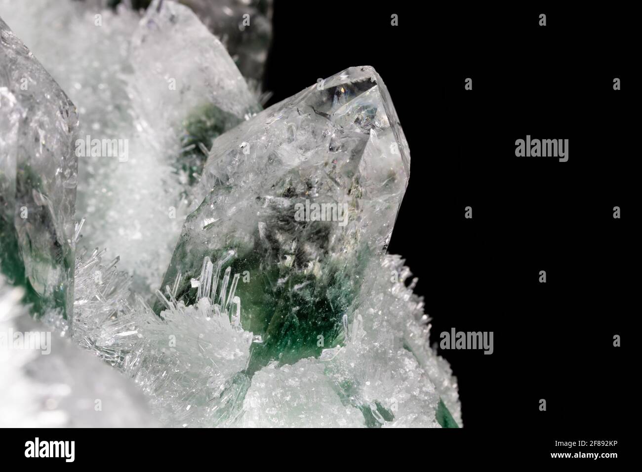 Cristales de cuarzo clorados del Himalaya. Los cristales más grandes, de color verde y blanco, están rodeados por cientos de pequeños cristales Foto de stock