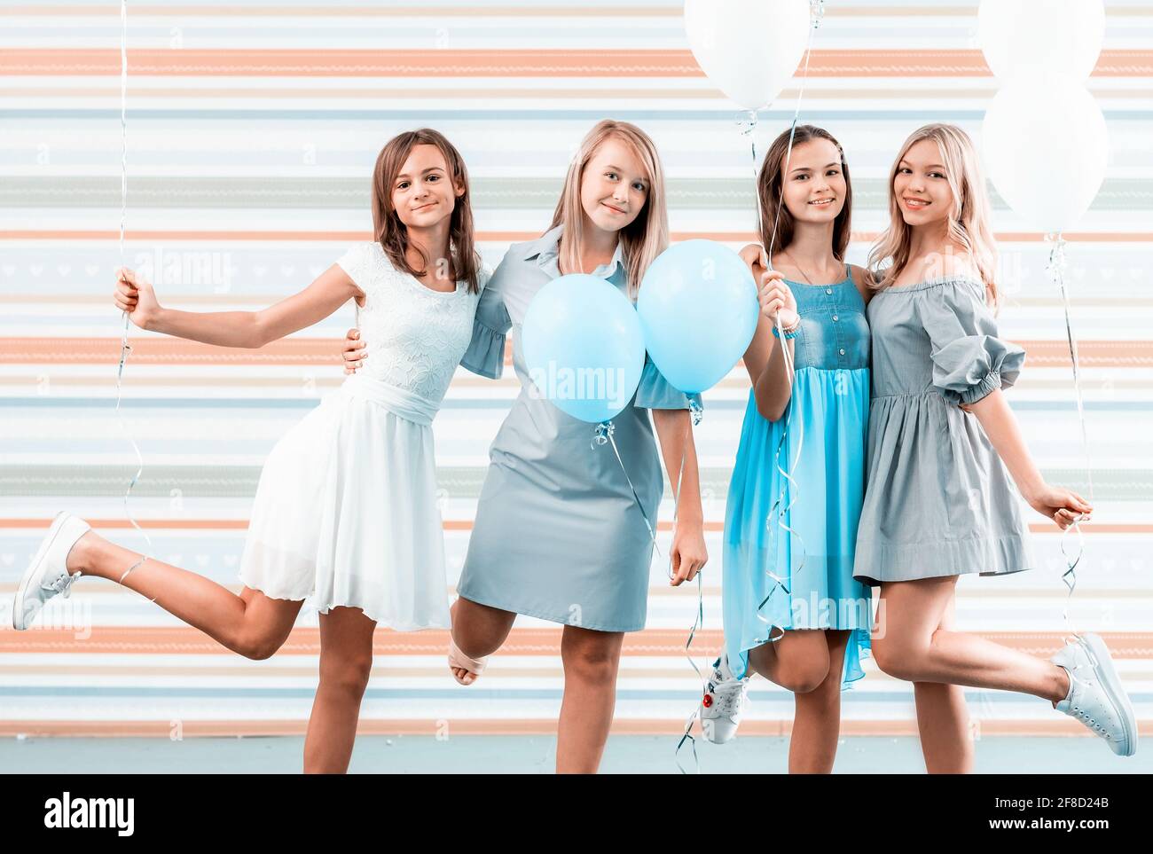Chicas hermosas en vestidos sosteniendo globos sobre fondo a rayas Fotografía de stock - Alamy Chicas hermosas en vestidos sosteniendo globos sobre fondo a rayas Fotografía de stock - Alamy