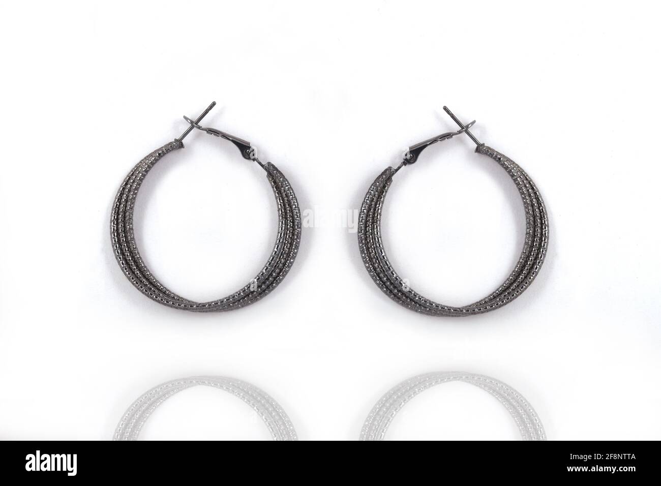 Pendientes redondos de plata negra, sobre fondo blanco, pendientes de plata joyería (India, árabe, africana, egipcia), pendientes de plata oxidada Foto de stock
