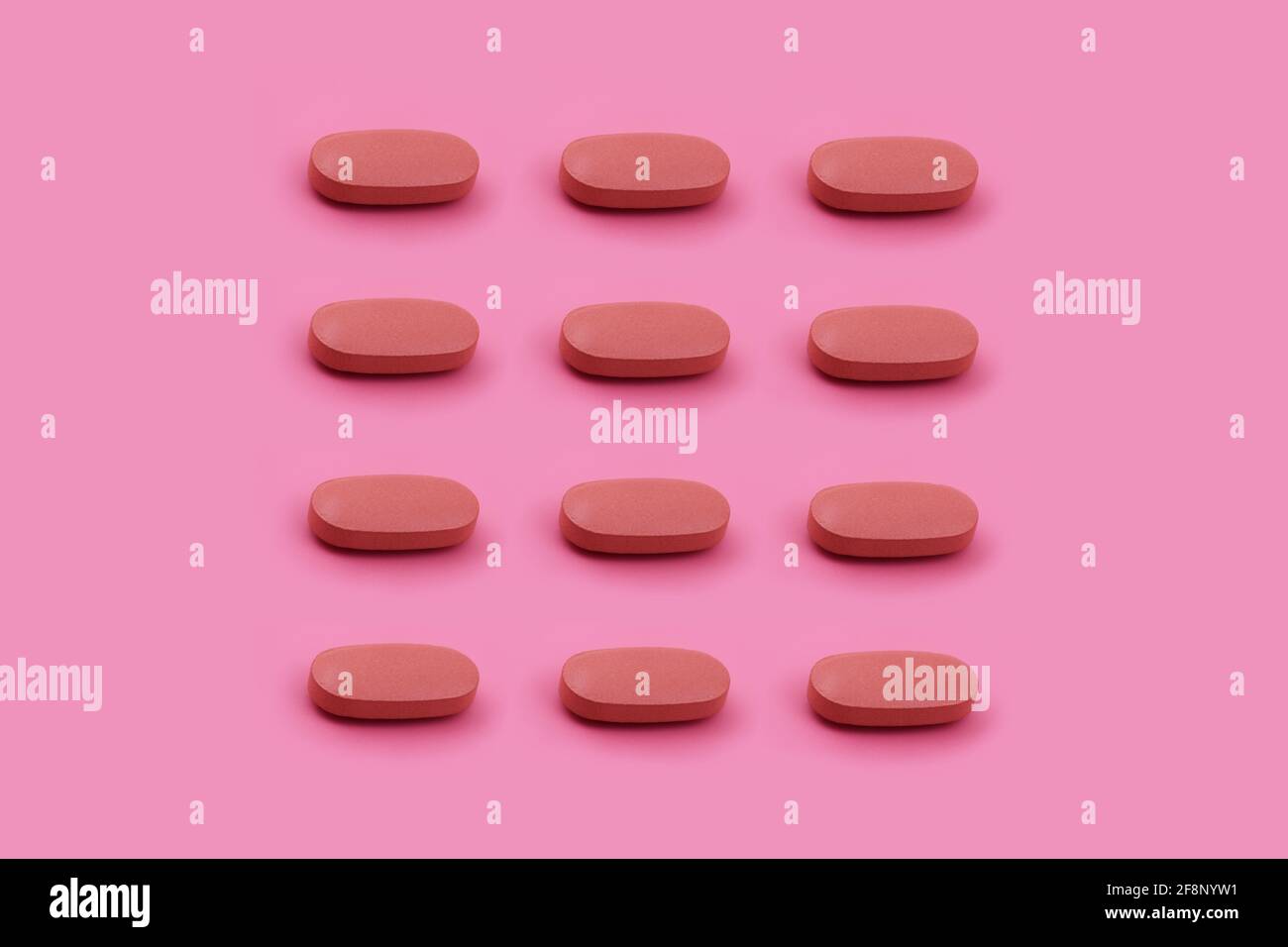 Forma ovalada tableta de medicina farmacéutica sobre fondo rosa, Medicina conceptos creativos estilo mínimo con fondo de papel colorido Foto de stock