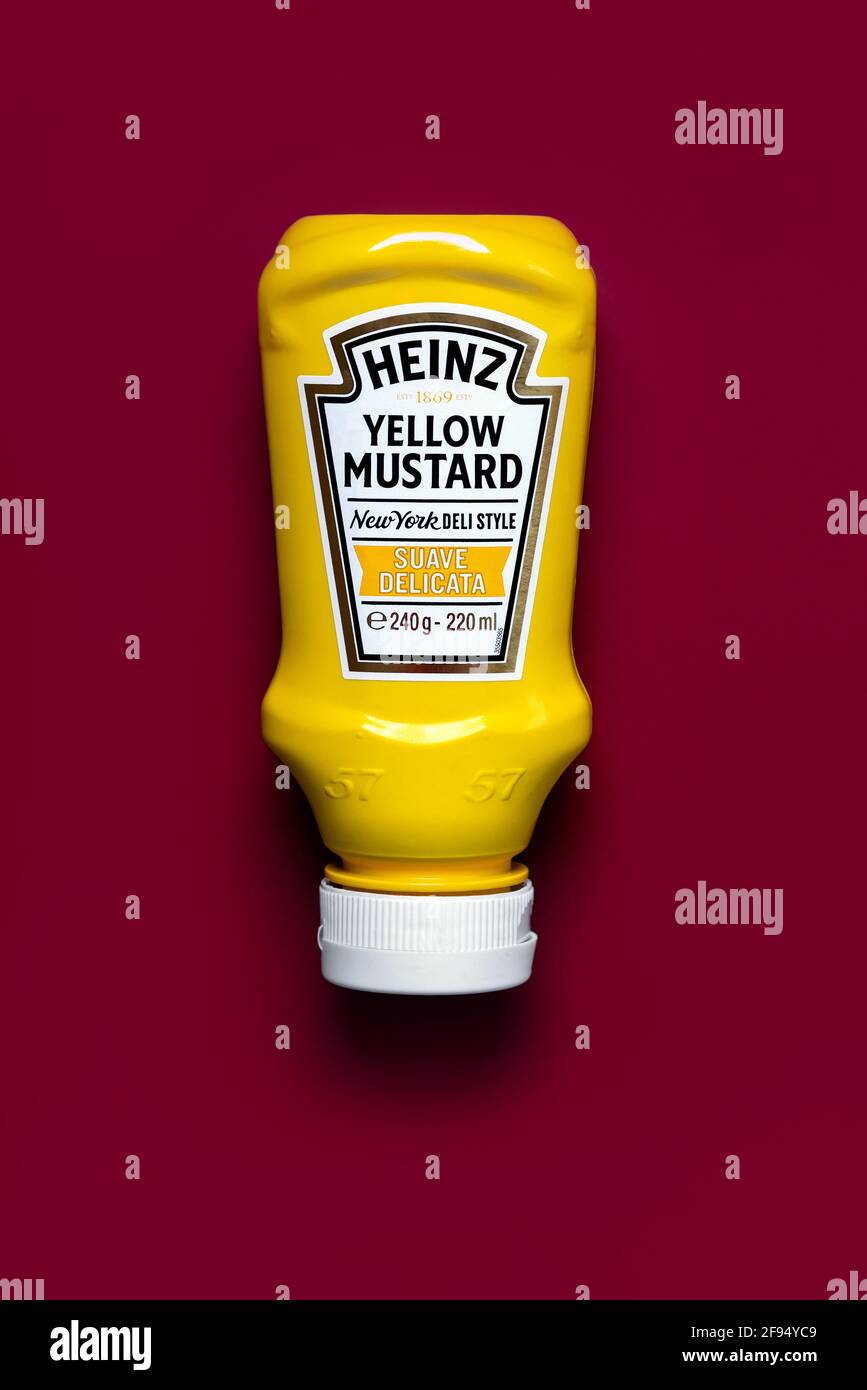 Botella de mostaza amarilla Heinz sobre fondo rojo Foto de stock