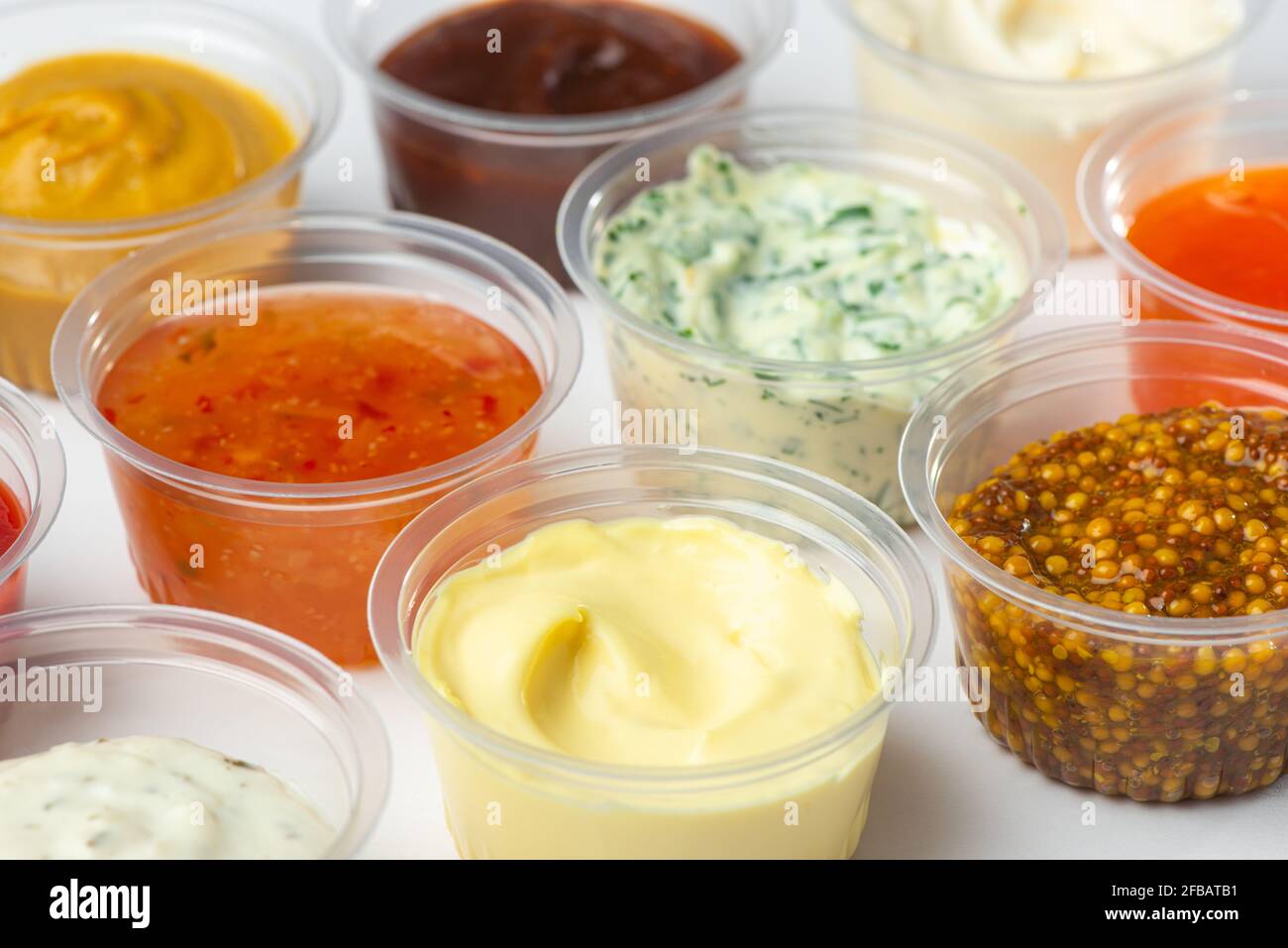 Variedad de salsas y condimentos diferentes en tazas pequeñas sobre mesa  blanca Fotografía de stock - Alamy